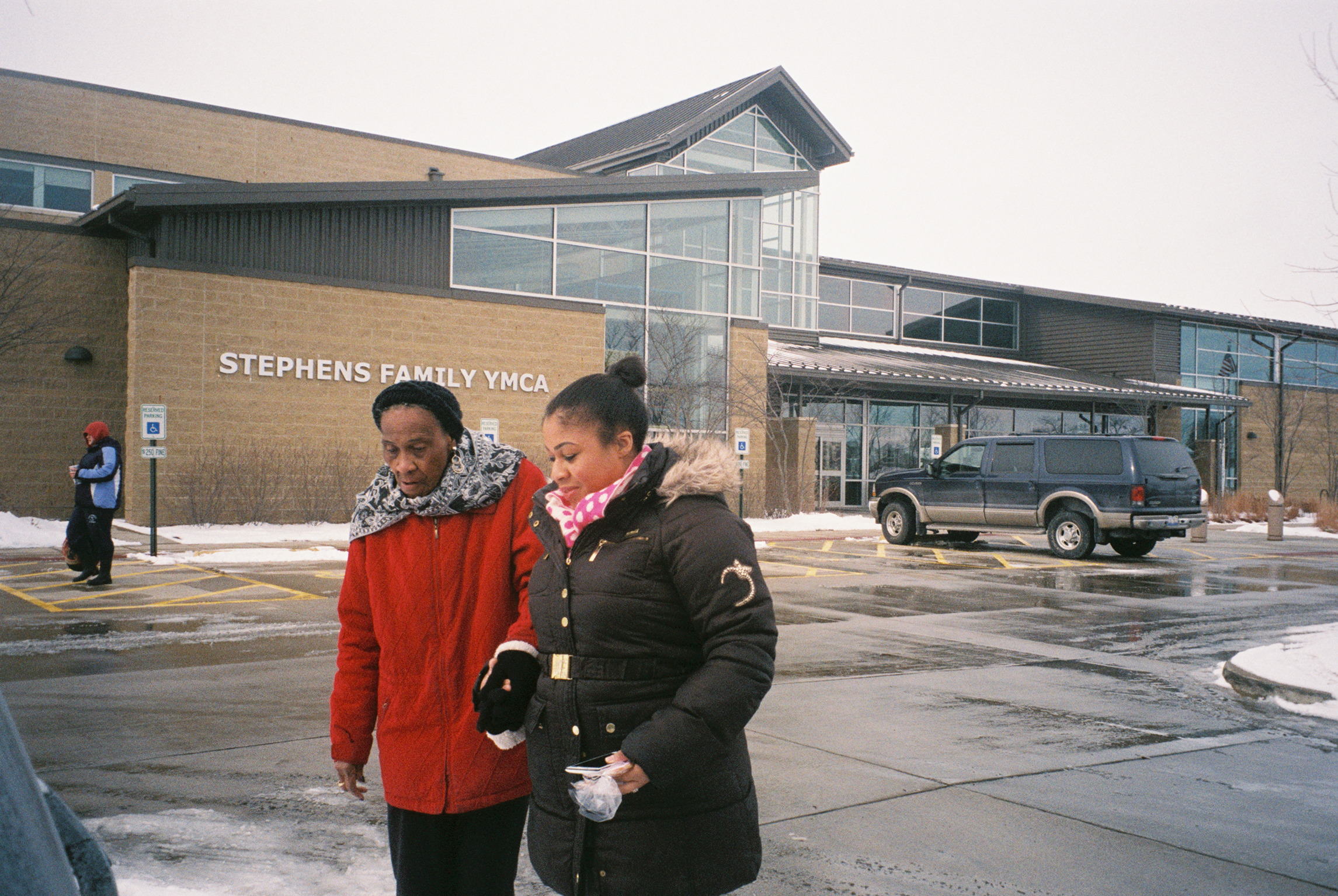  Nesa walks Shirley, 80, to the car after an exercise class at the YMCA in Champaign, Ill. Nesa works as a private home care aid during the week. 