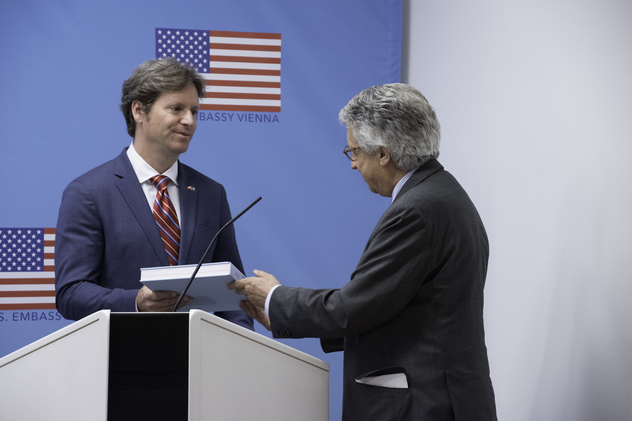 The Ambassador of the United States to Austria, Trevor D. Traina (left) receives a book on the Marshall Plan in Austria from Ambassador Wolfgang Petritsch (President, Austrian Marshall Plan Foundation) during the symposium. Credit: U.S. Embassy/ A. Slabihoud