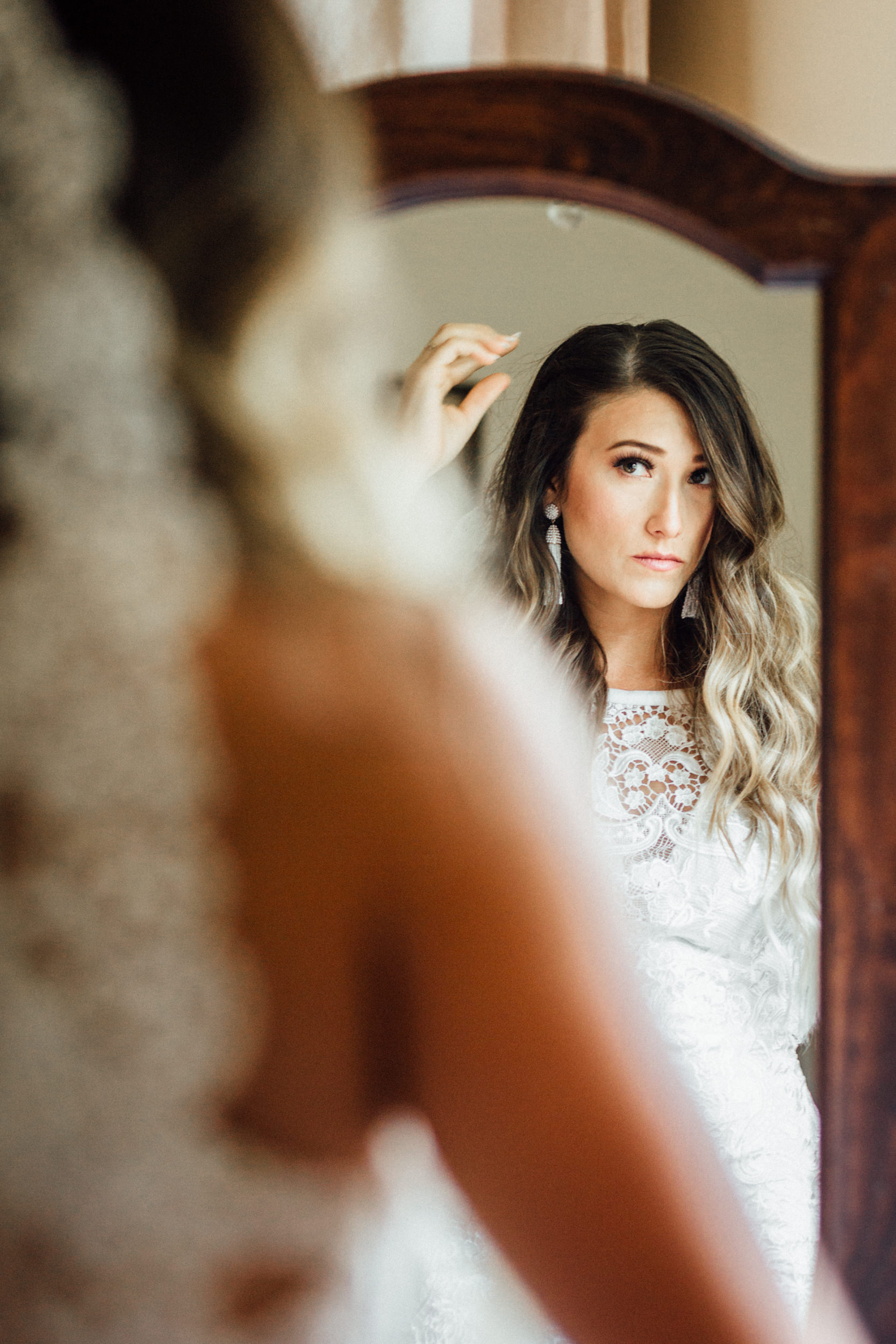 AK bride getting ready in front of antique mirror