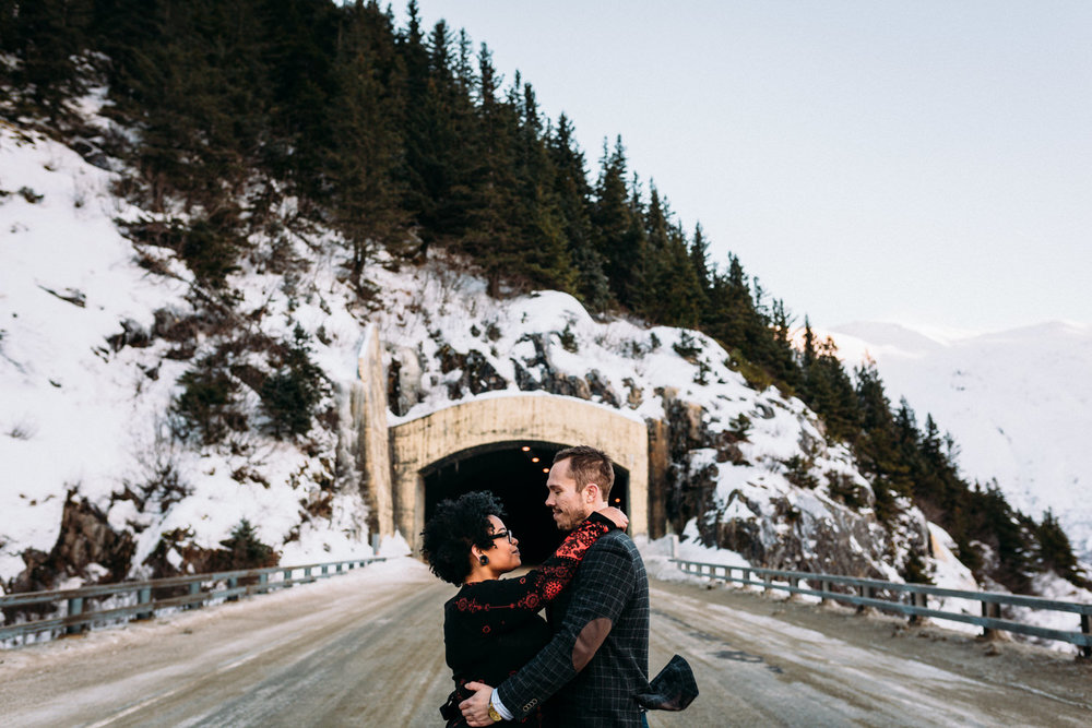 Couple in front of tunnel in Portage Valley Alaska