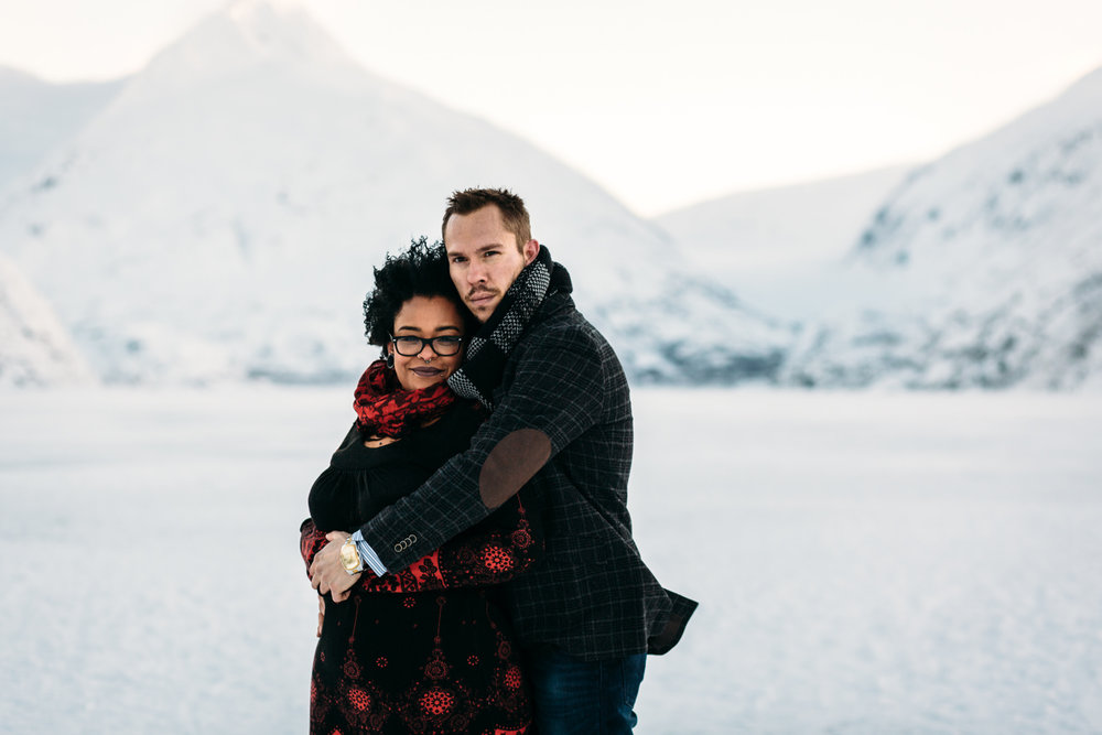 couple hugging during engagement photos in alaska