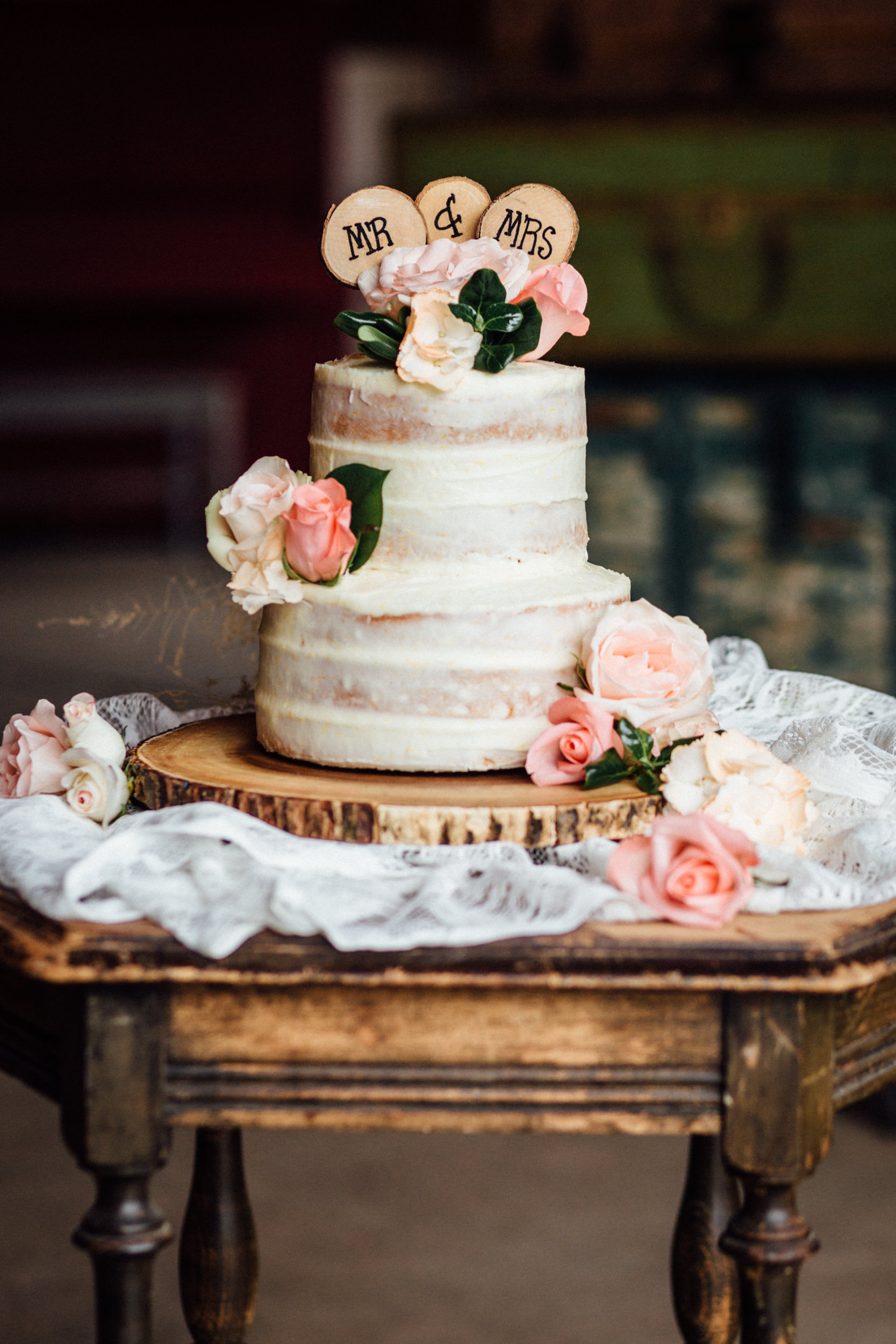 Three-layer wedding cake with pink flowers