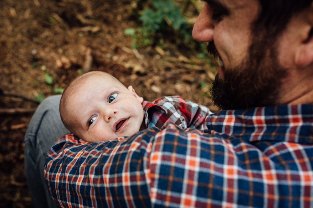 Dad looking down at baby Adam