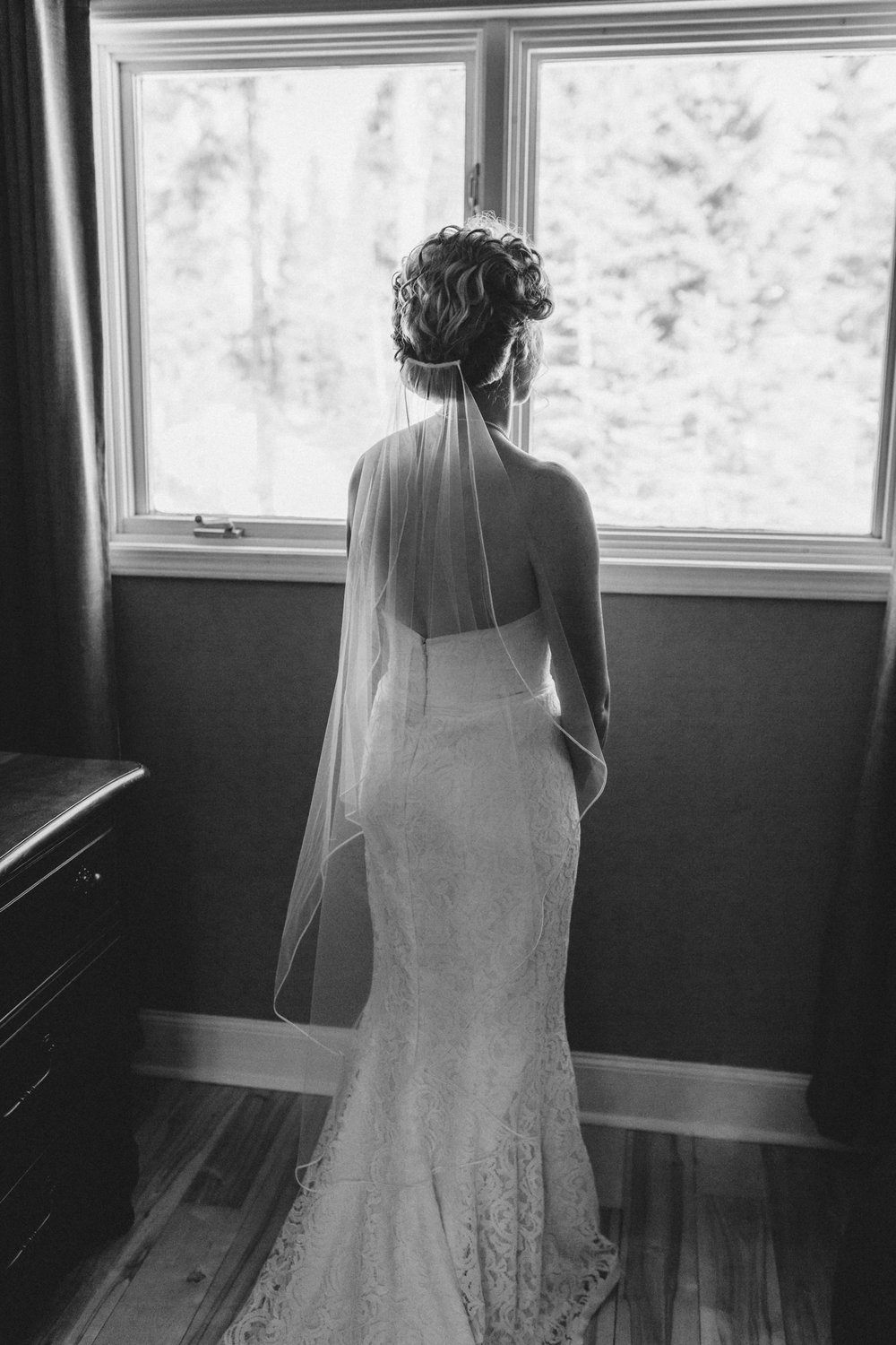 Portrait of bride looking out the window