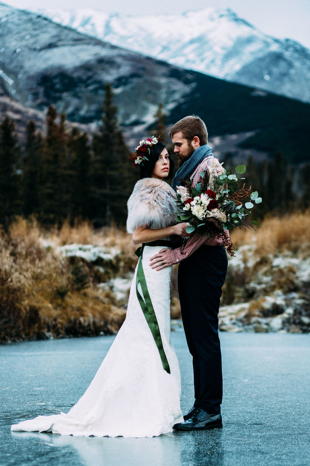 Bride and groom standing on ice in Alaska