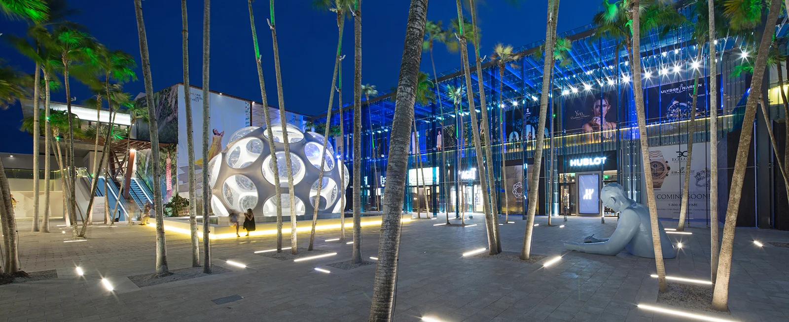 Palm Court Plaza with Buckminster Fuller's Geodesic Dome in the foreground and Palm Court Event Space in the upper left corner behind the palms.