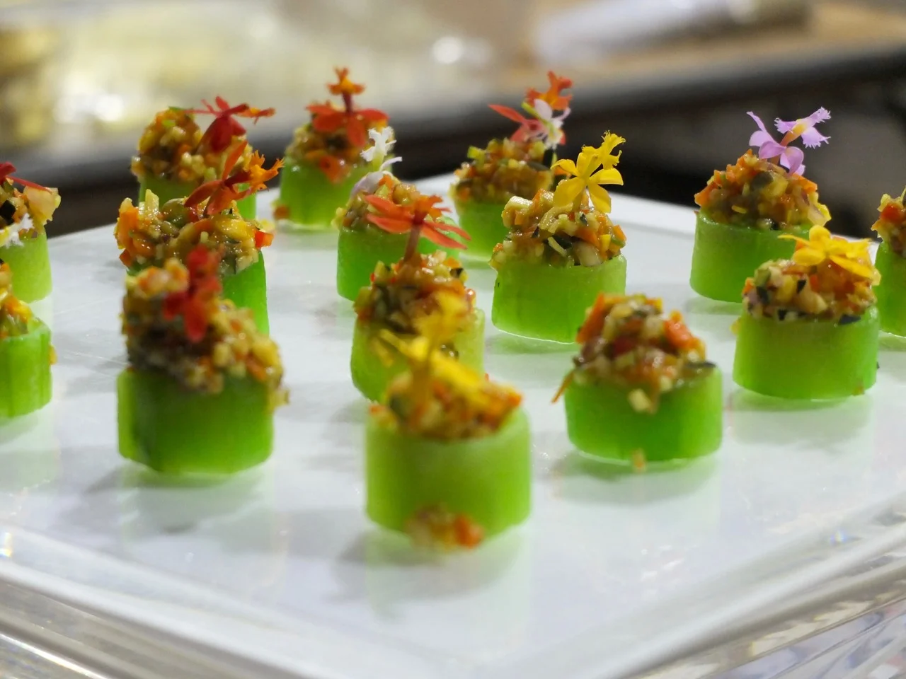 Vegan Hors D'oeuvres: Veggie Tartar in Cucumber Cup with a Micro Flower