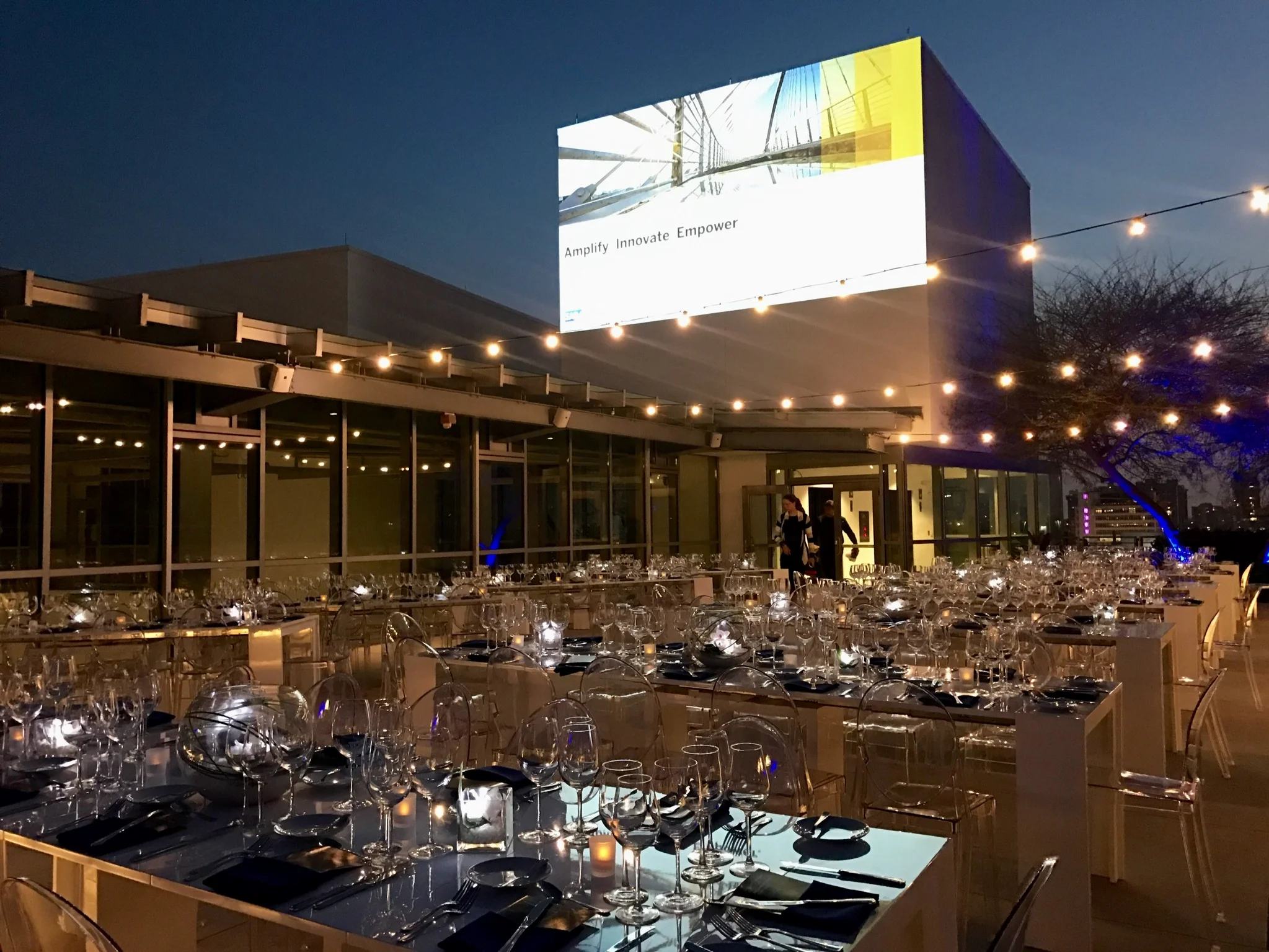 Set up for a corporate dinner on the rooftop of the New World center