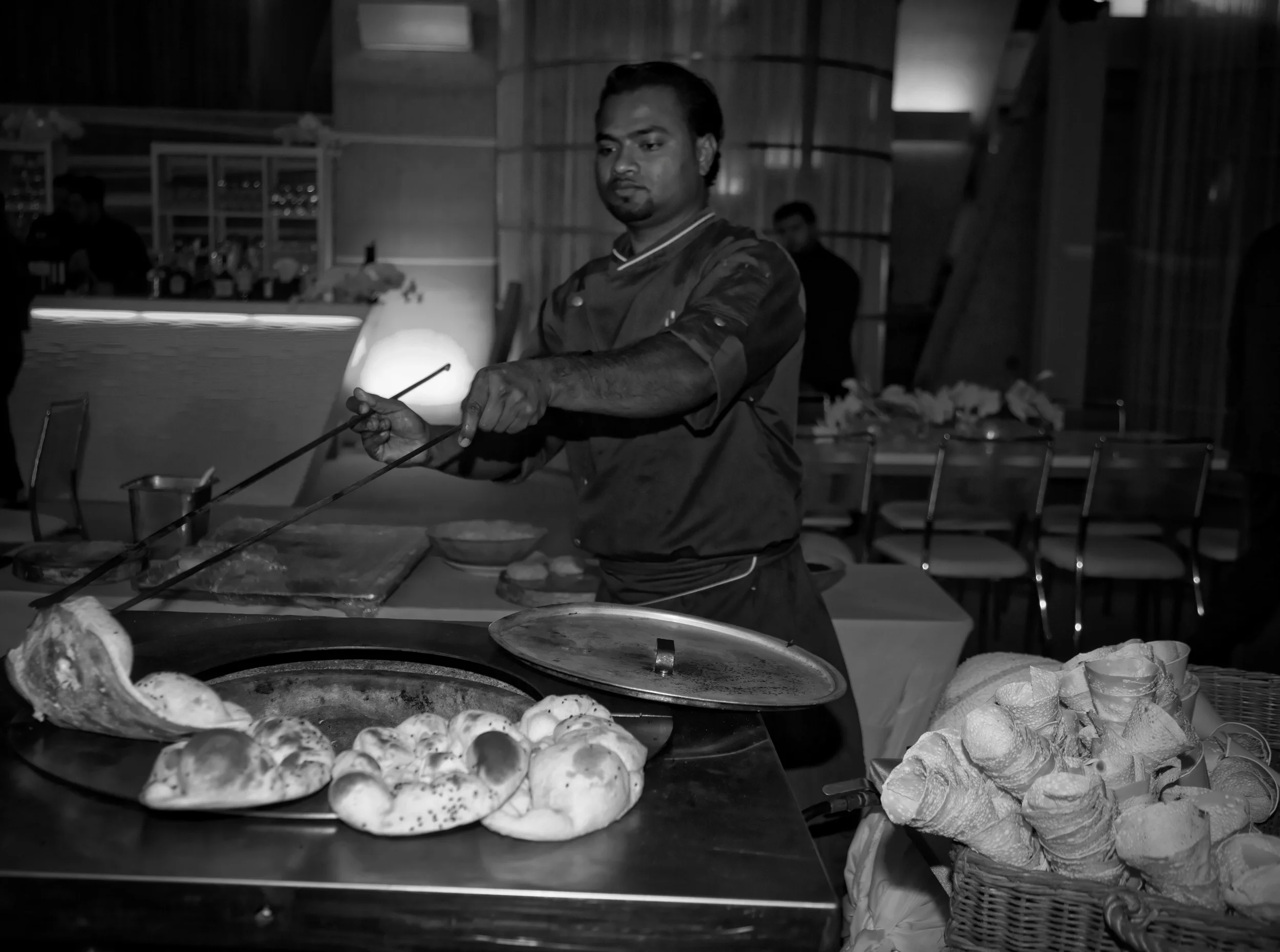 NAAN STATION: Chef Anthoni cooking Naan in a traditional Tandoor Oven at a corporate event. 