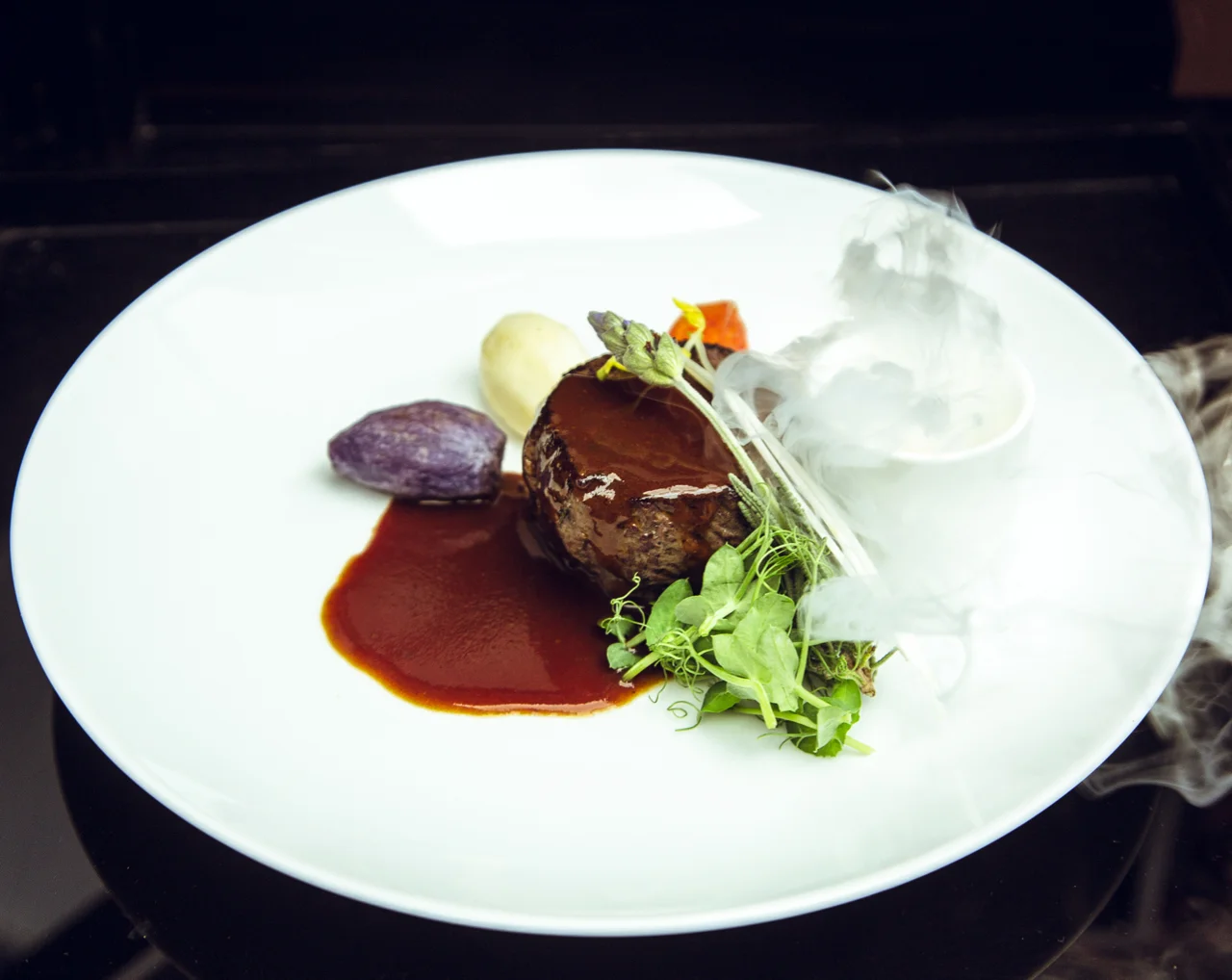 VENISON LOIN, Paired with The Macallan M (Under Cloche, Sauced Tableside,) Scotch Whisky & Herb Fog, Sauce Perigueux, Vegetable Bouquetiere