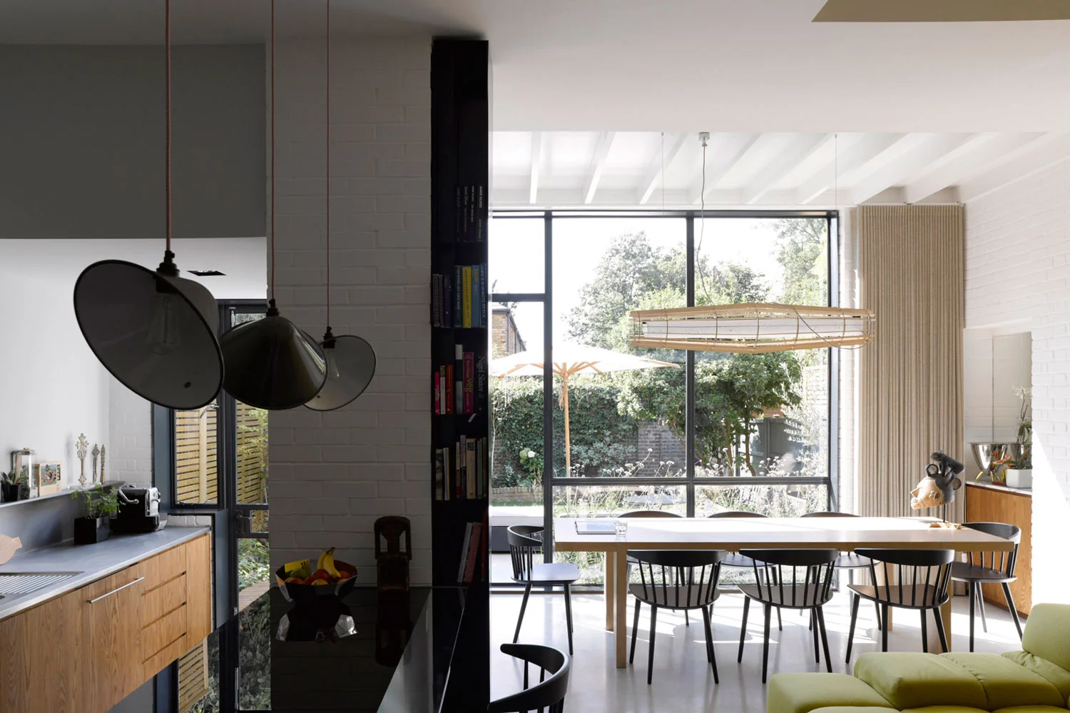 Our clients live in a 1930s house in Balham with their two young sons. One half of the couple had been raised in a modernist house in Belgium, surrounded by a collection of 20th Century Art while the other grew up in a mountainous region of Switzerland. Their sensibilities led them to give Liddicoat & Goldhill an open brief to adapt and expand their home, which had already been ‘opened up’ at ground floor level by previous architects. Liddicoat & Goldhill’s response addressed the entire house, and was based on analysis of the family’s living patterns, and by making only the most economical structural changes. The interior layout was fully remodelled, with the most invasive and dramatic work happening at ground floor level and in the cramped circulation space, where an efficient and sinuous new staircase was added. Selective re-instatement of previously-demolished walls reinstated the formal drawing room, facing the street, while a stepped extension to the rear created an open plan eating, cooking and informal relaxation area. The first floor was re-arranged to create a guest room, study and luxurious master suite with a meandering route from the sleeping area into the dressing and bathroom spaces. By extending at roof level, we created two new children bedrooms suites. These were designed to overlap the different functions of sleeping, entertaining and studying. The rooms have large structural glazed windows with integrated desks affording panoramic views across SW London. Aesthetically, the project has been conceived as a collage; a deliberate response to the vogue for monochromatic interiors. A rich mix of strongly-contrasting colours and textures creates a warmly tactile environment. In the kitchen, rough painted brickwork meets crisp plasterwork, black glass, stainless steel and strongly-grained wood. These provide the backdrop to carefully-chosen pieces of contemporary and mid-century Danish furniture, set against heated polished concrete floors. Key to the design was the combination of the clients’ existing furniture and art with new purchases and pieces designed specially for the project. Liddicoat & Goldhill design and make furniture and objects - certain pieces were created specifically for the Janssens-Kobler house; the architects worked with specialists to fabricate these items. Particular noteworthy elements include the laser-cut timber ‘Corral’ lamp hanging over the dining table is designed and made by Liddicoat & Goldhill.