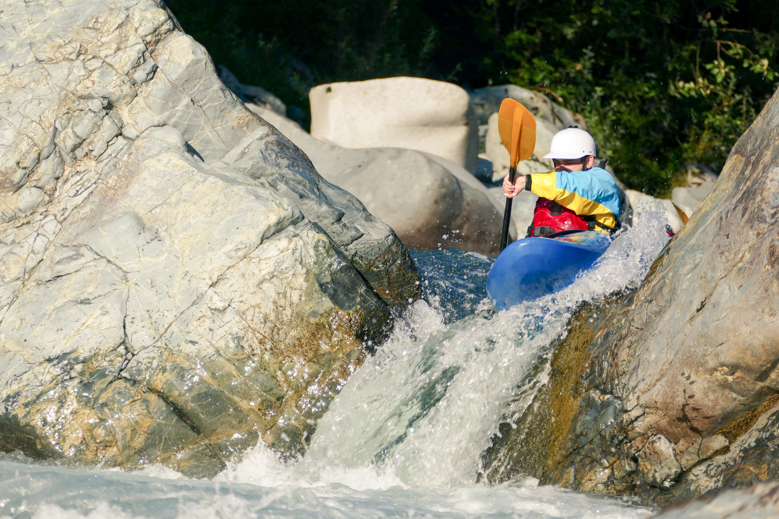 Extreme_Kayaker_Going_Over_Rocky_Waterfall_Drop_in_Raging_River_Rapids.jpg