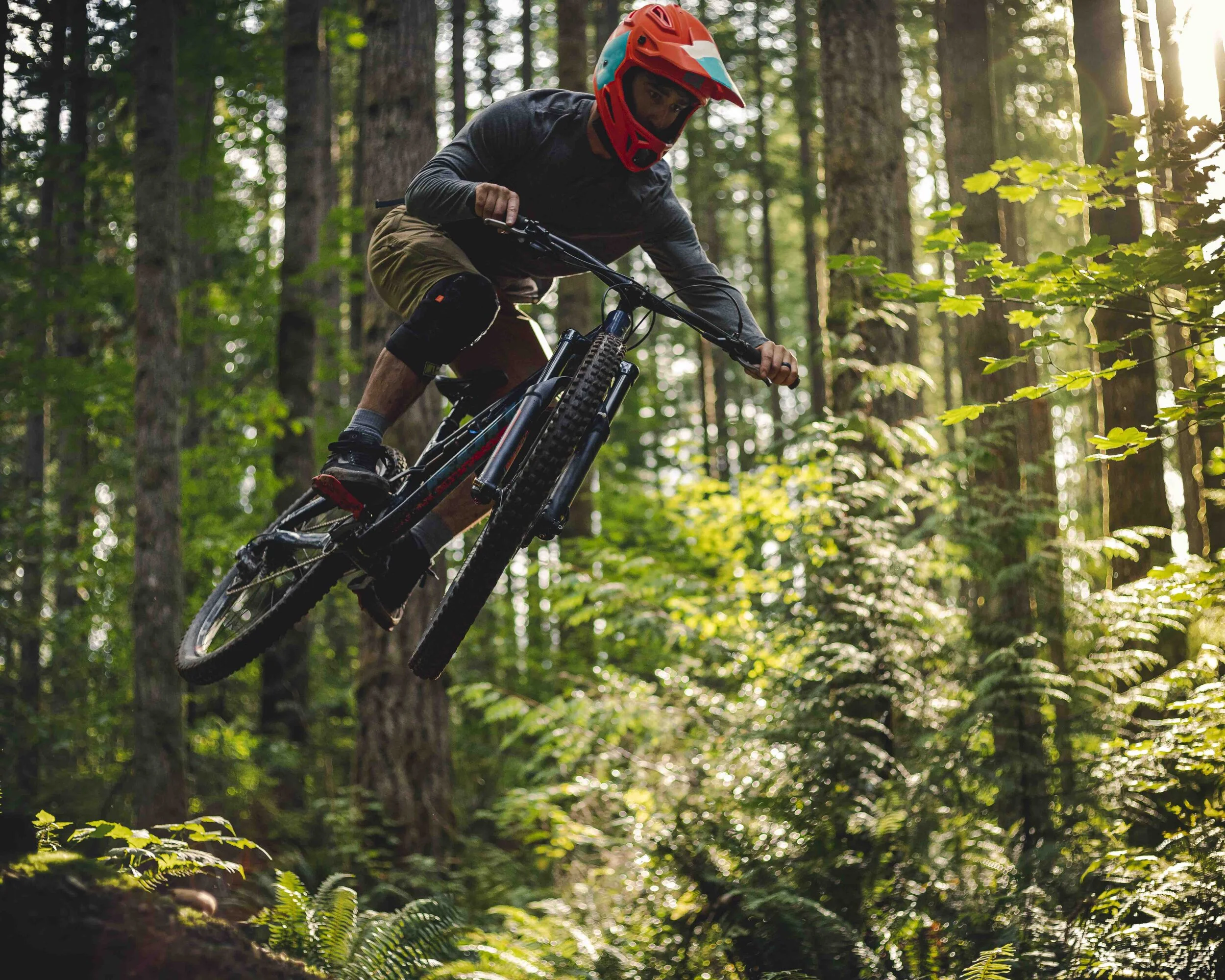 Intense_Mountain_Bike_Riding_Catching_Air_on_Forest_Trail.jpeg