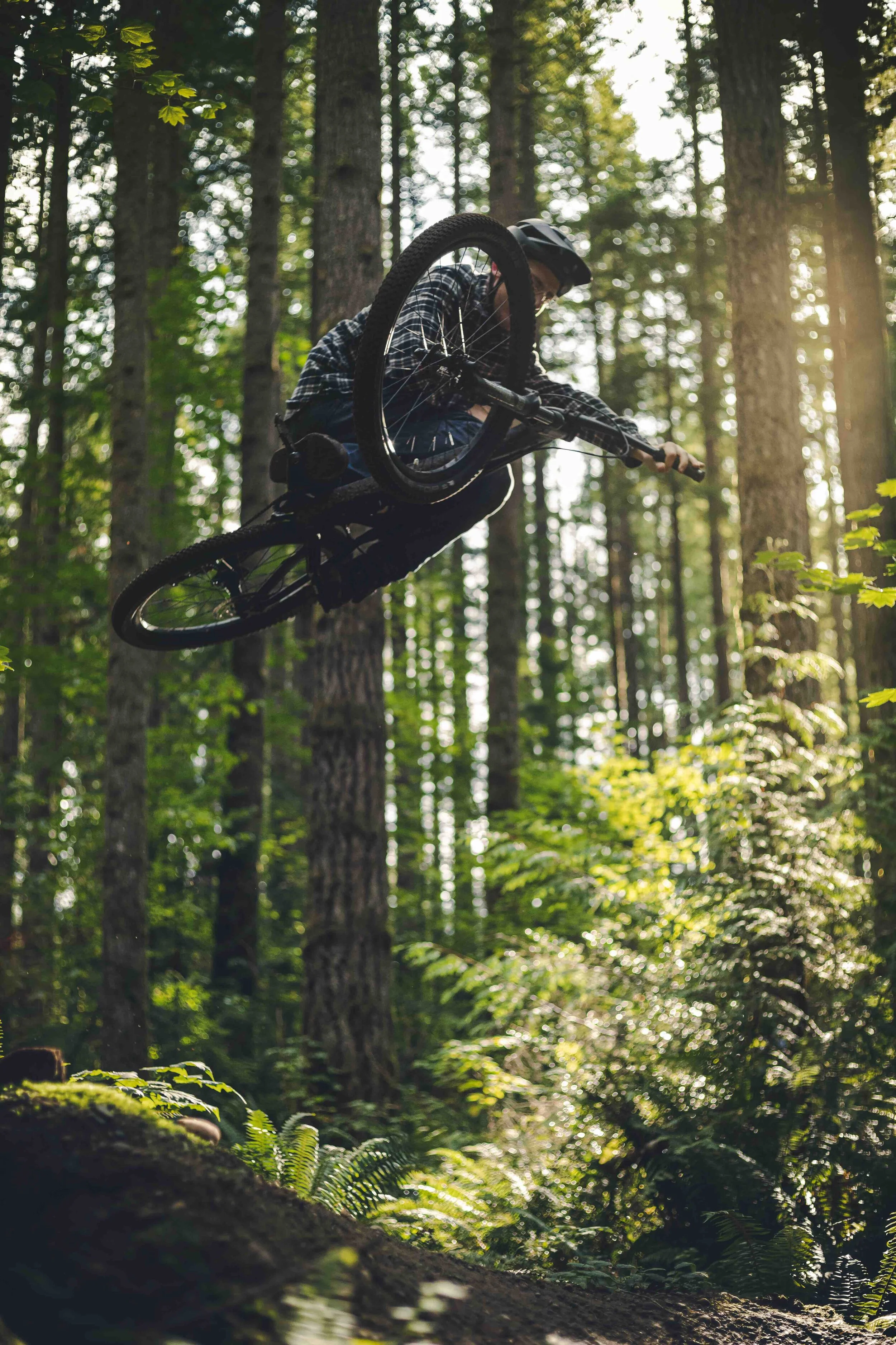 Stylish_Mountain_Bike_Air_with_Sideways_Trick_Over_Forest_Trees.jpeg