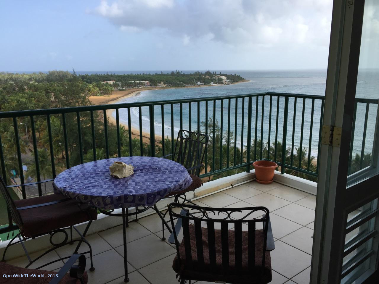 Renting a condo can be an economical option when traveling, especially when the unit has an equipped kitchen and in-unit laundry facilities. Shown here: morning view from the balcony of Dulces Sueños rental unit in The Towers of Luquillo, Puerto Rico