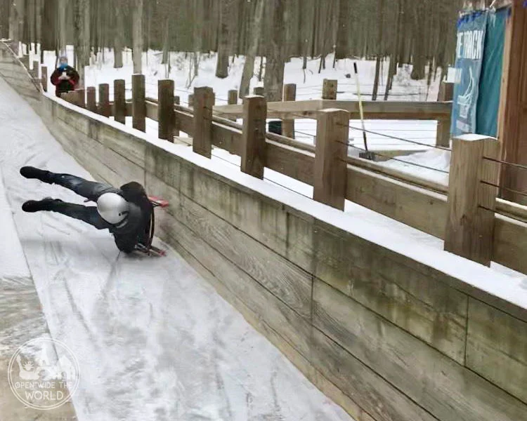 This luger repeatedly tried to overpower his sled rather than working with it. And he repeatedly wiped out. Muskegon Winter Sports Complex, Michigan. #luge #openwidetheworld