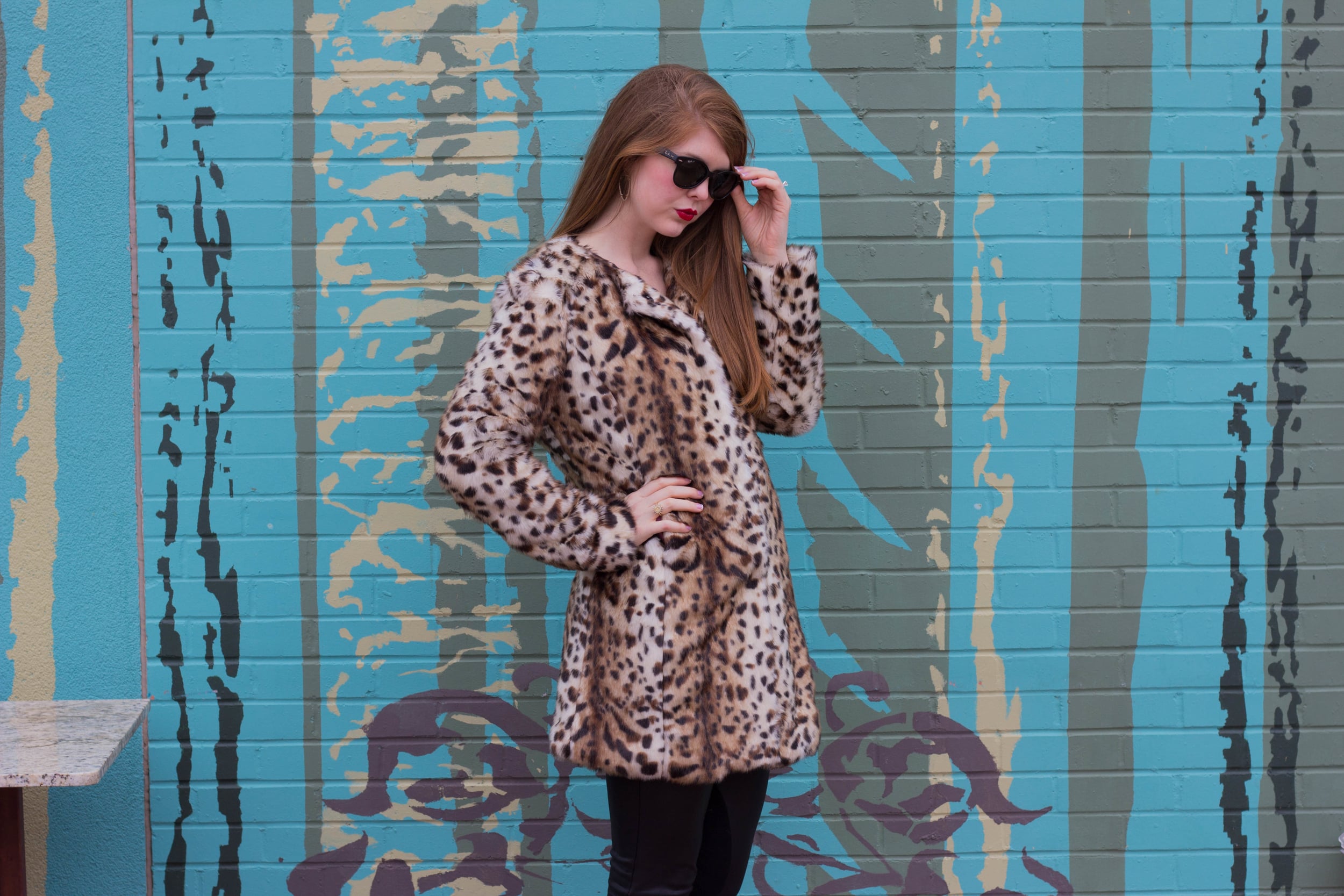 leopard coat, leather tights, black raybans, red lip