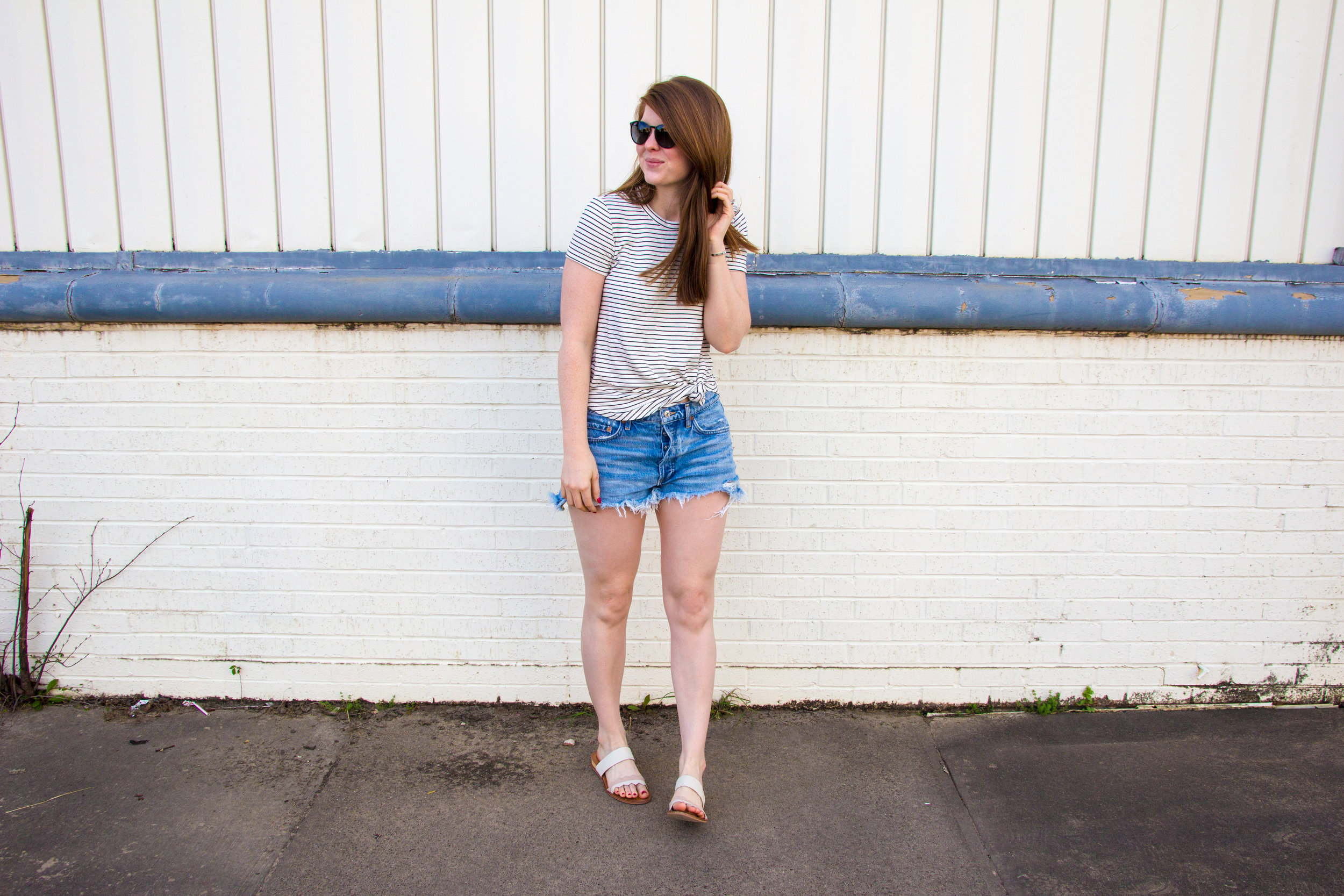 longer denim shorts, agolde parker denim shorts, daily ritual supersoft terry tee, ray-ban erik sunglasses, white slides sandals, 31 bits together bracelet, thirt one bits, denim shorts that are longer than one teaspoon, cut-off jean shorts that are…
