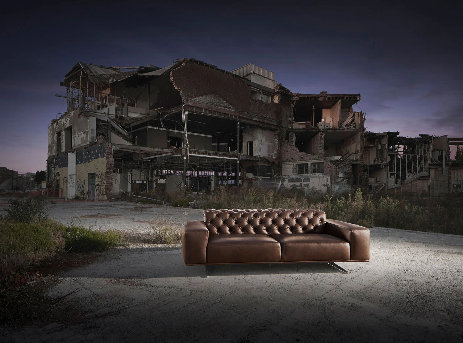 Designer sofa in front of an earthquake-damaged building