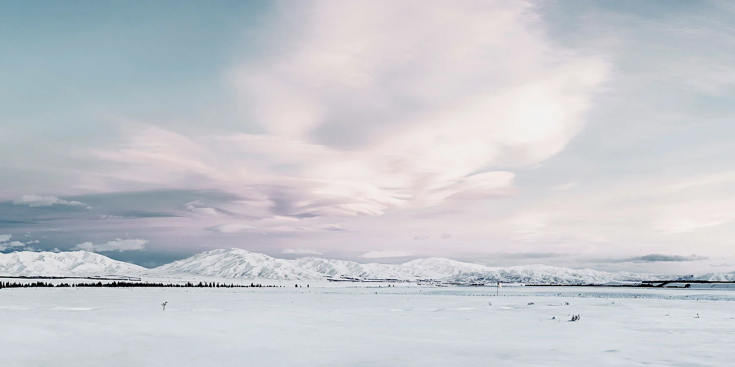 Snow-covered fields and mountains in McKenzie Basin