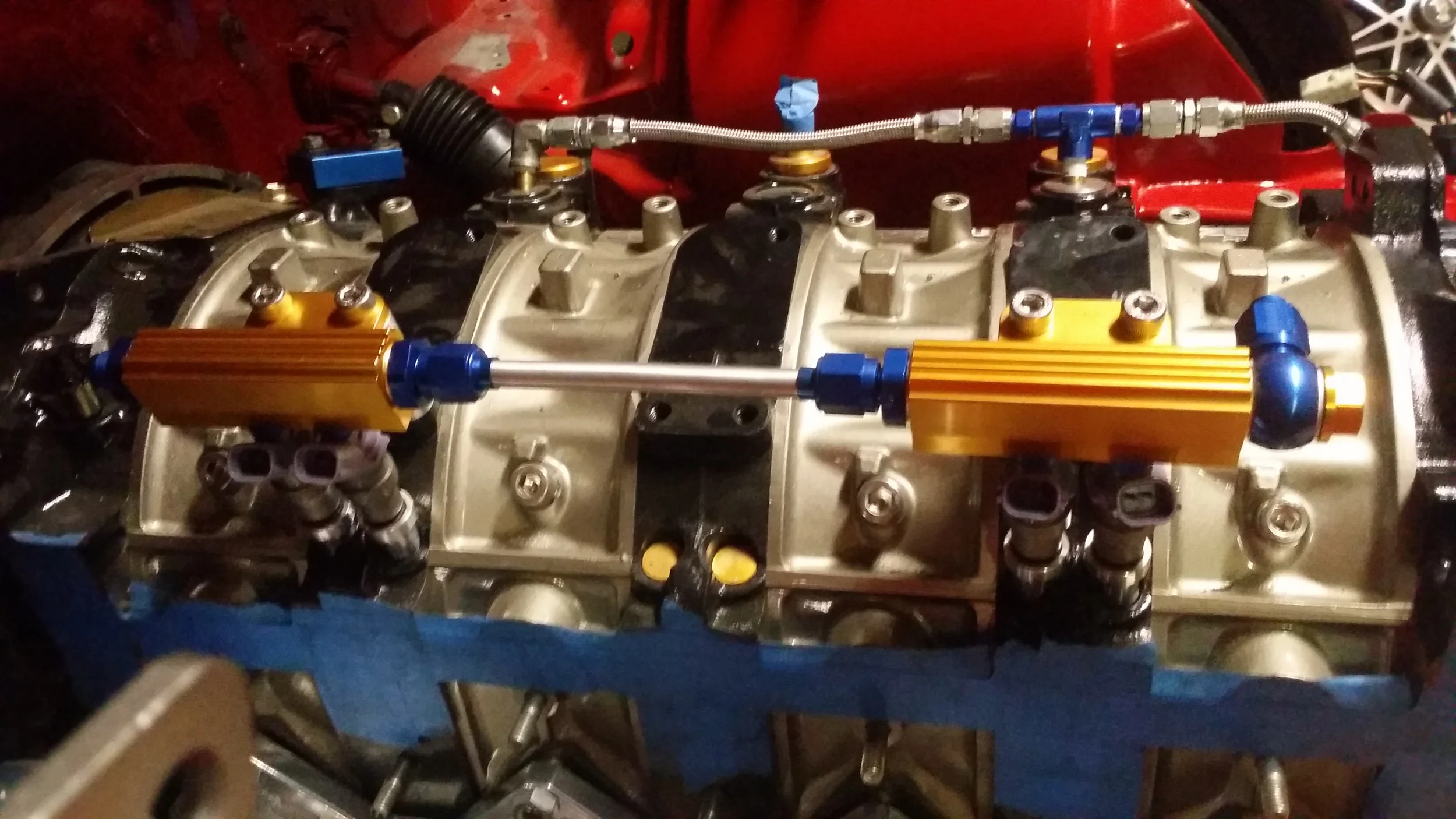 Aluminum hard line connecting the primary rails and a banjo bolt at the new inlet.