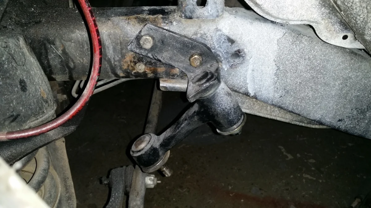 The left bolt (as you are looking at it) is the hole that was added to the frame to flip the Idler Arm.