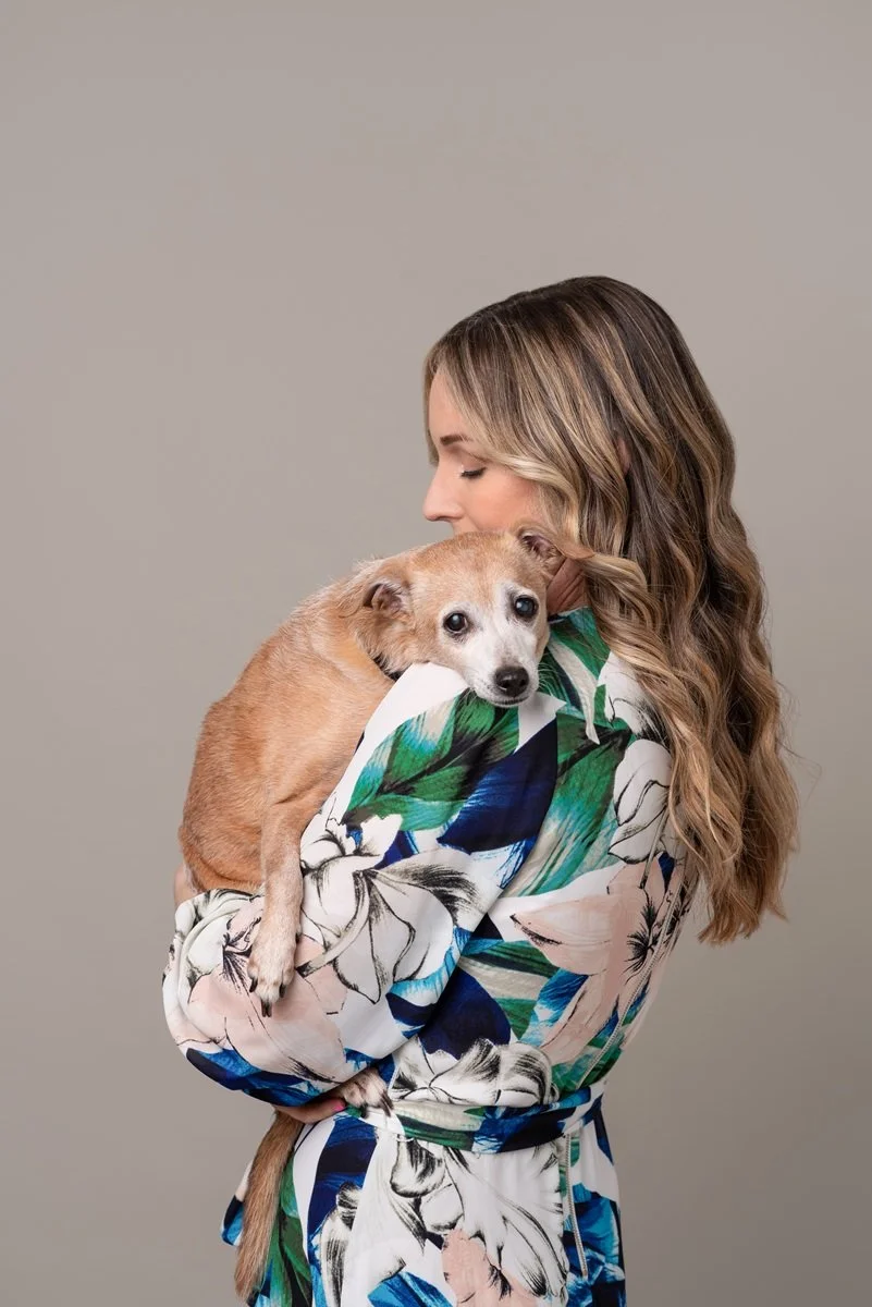 woman snuggling senior dog sweet studio portrait