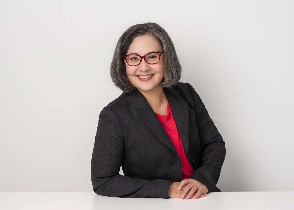 friendly headshot woman with glasses