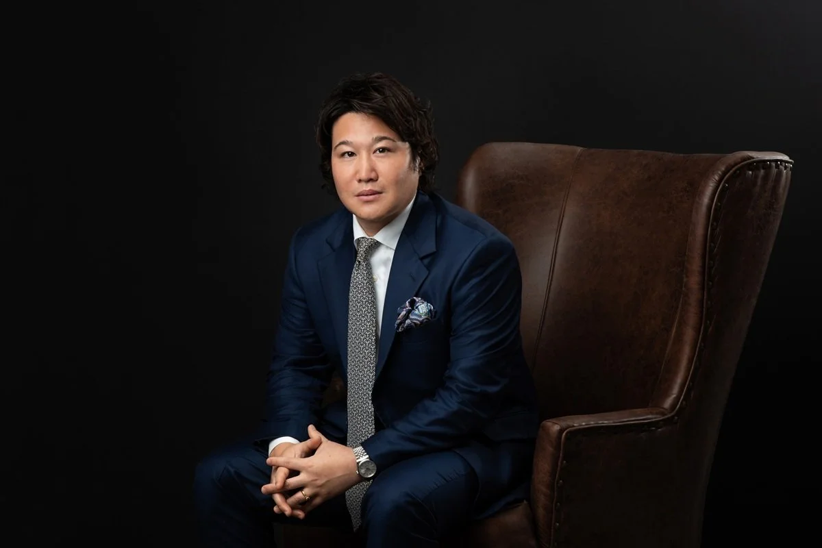 interesting headshot of business leader wearing suit and tie