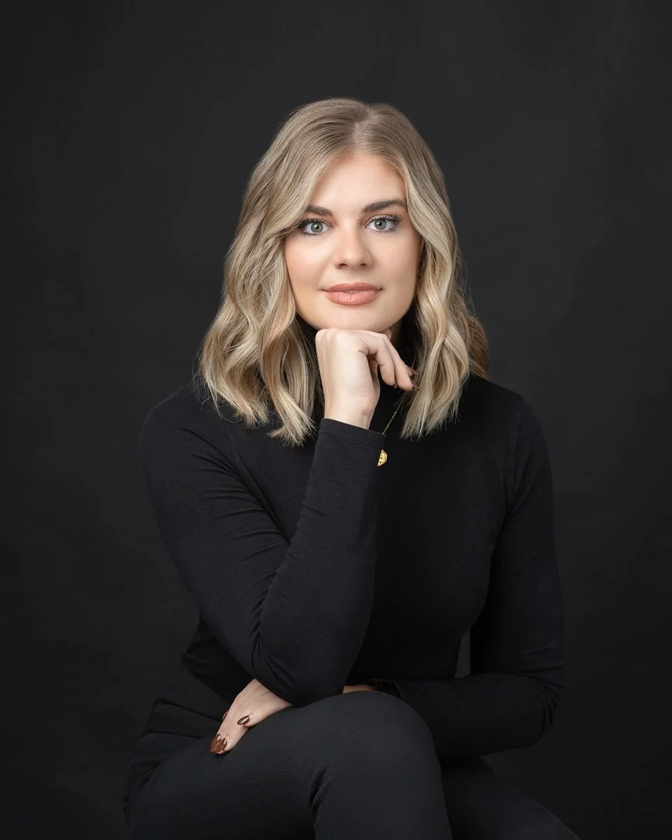 thoughtful headshot of woman wearing black turtleneck