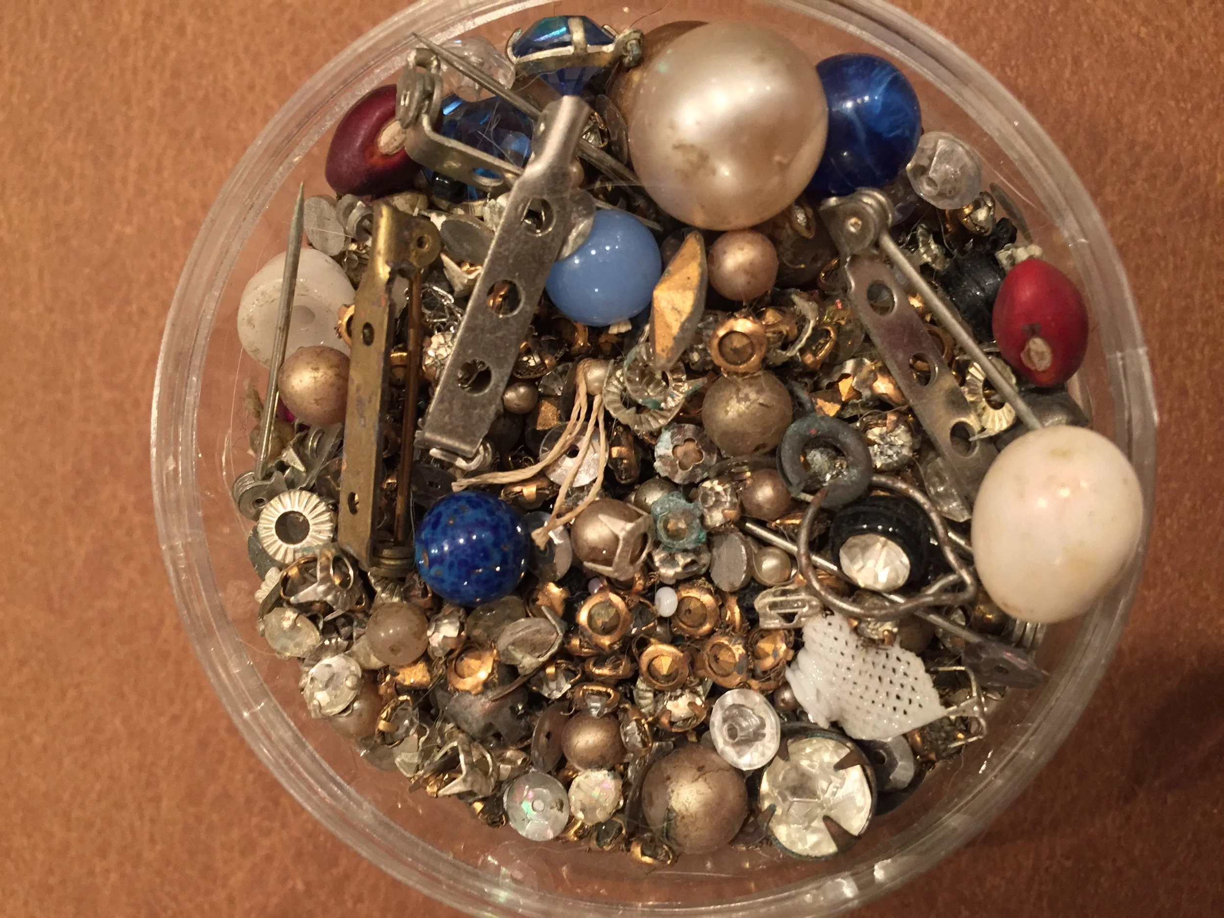  A sampling of some of the beads and jewelry findings that my grandmother had that she kept in a large glass jar.&nbsp; Who knows how old some of this stuff was.&nbsp; See the little piece of mesh at the bottom right corner?&nbsp; That is a broken pi
