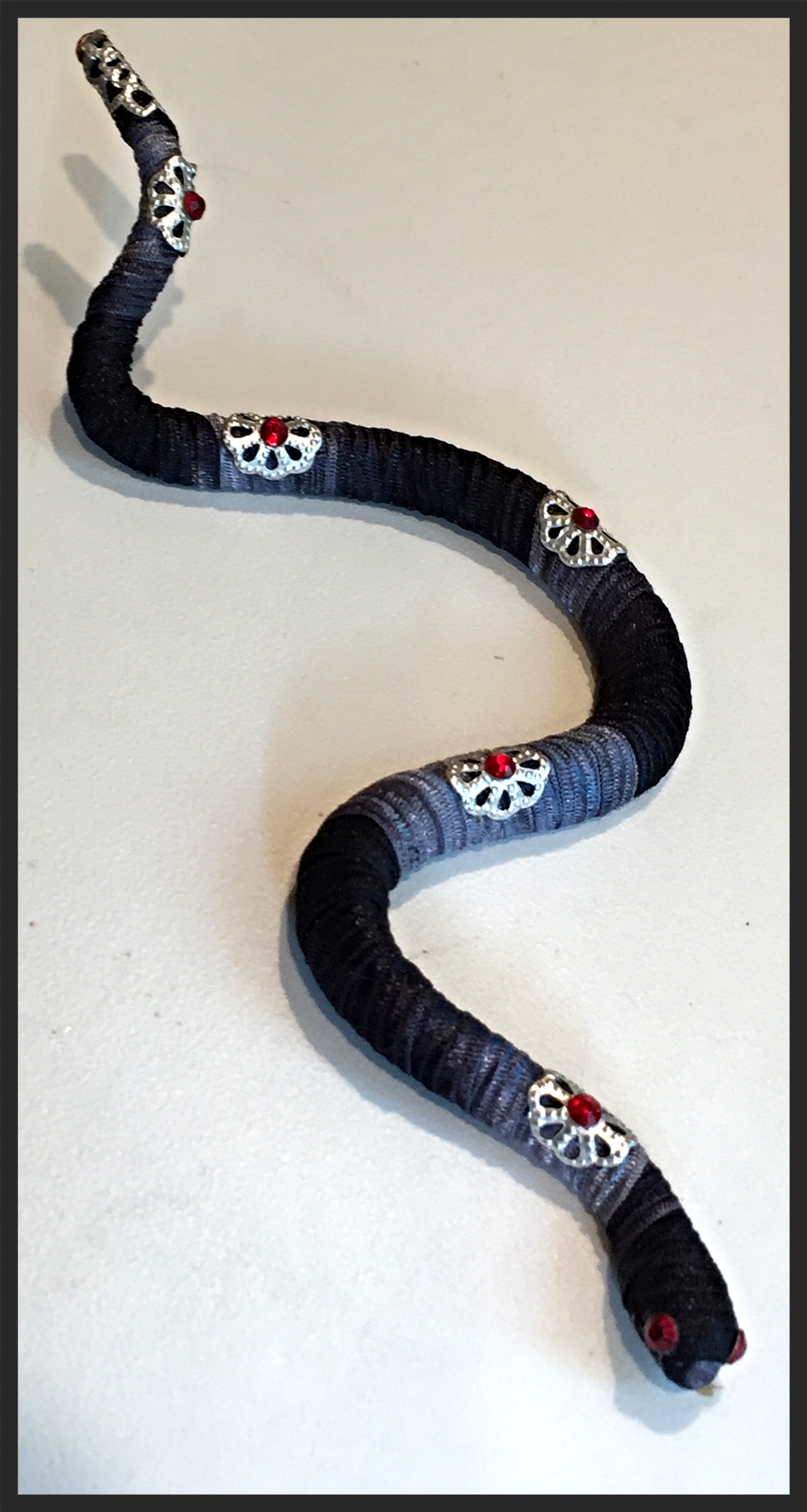  Snake pins are about 5" to 6" long.&nbsp; The pin back is placed usually in the middle of the body so it will lie flat when pinned. 