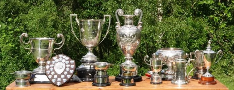 Photo of the Fullbore Scottish Open Championships Trophies and Prizes displayed on a table out doors at the Jubilee Range Blair Atholl