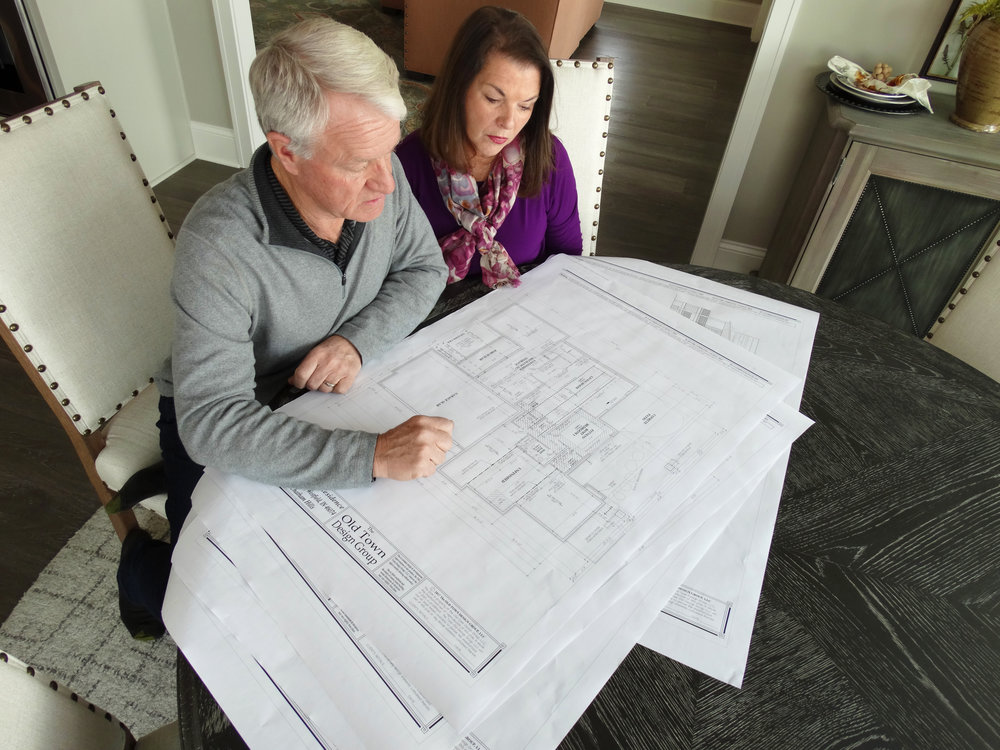 Home owners Jim and Maureen review the final plans of their dream home.