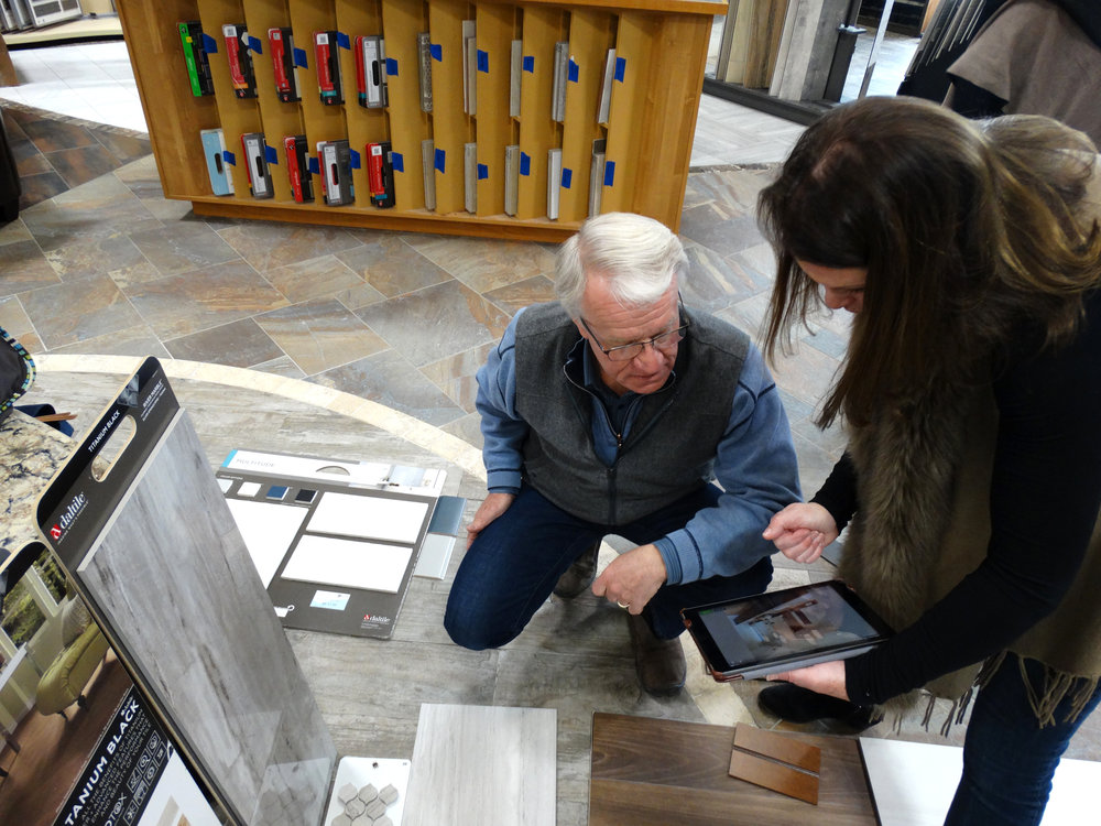 Jim and Maureen looking at samples of flooring and tile.