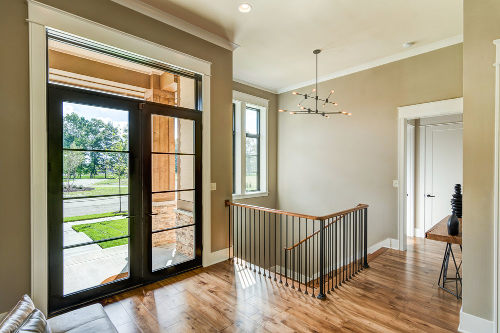 Black window casings add a dramatic flair to this nature inspired home.