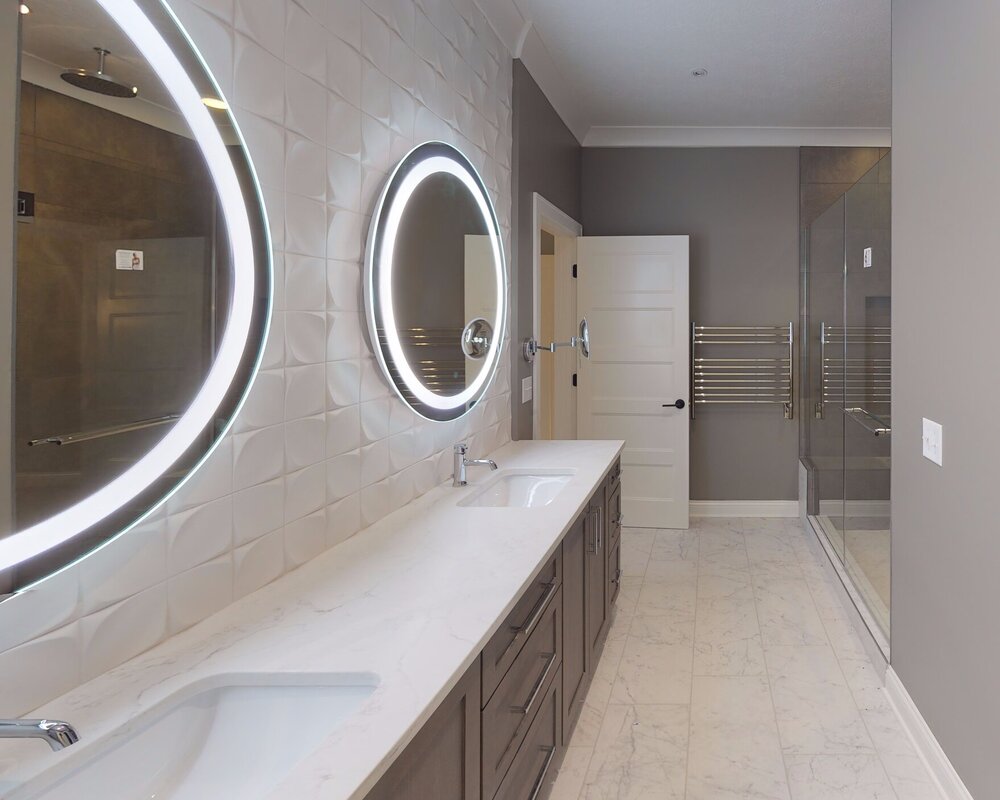 A crisp white textured tile adds to the modern effect of this master bath. Designed by 10inHouse .