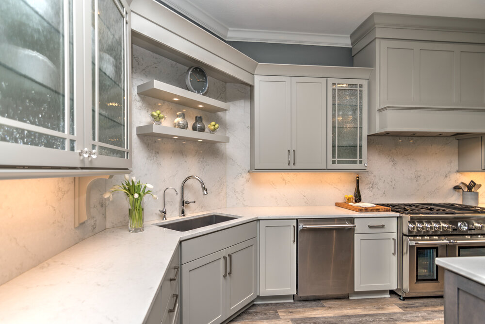 Utilizing a full piece of slab as a kitchen backsplash creates harmony in this kitchen.