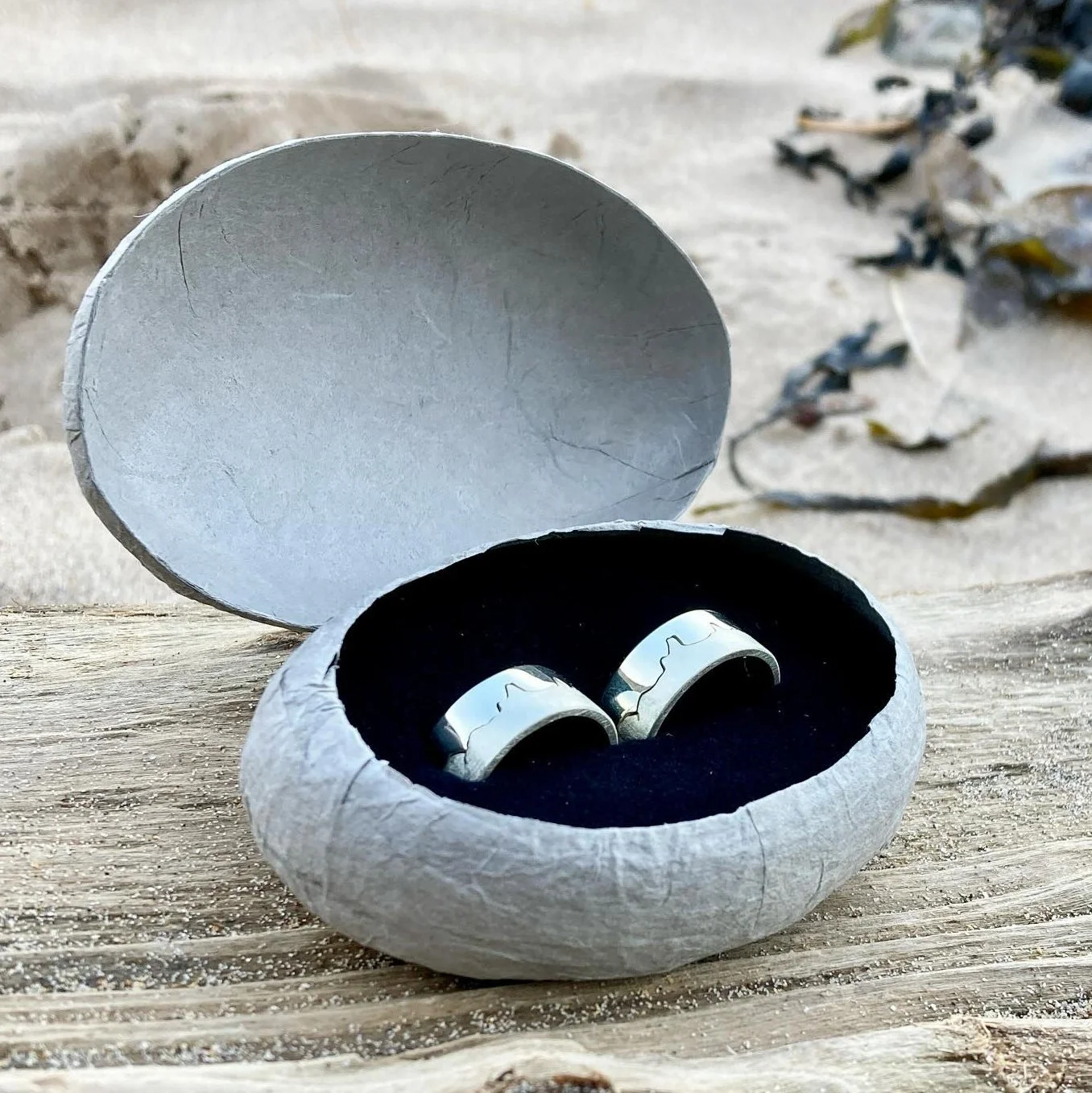 Pair of white gold coastline wedding rings inspired by North Devon, including Woolacombe, Croyde Bay, Morte Point, and Baggy Point.