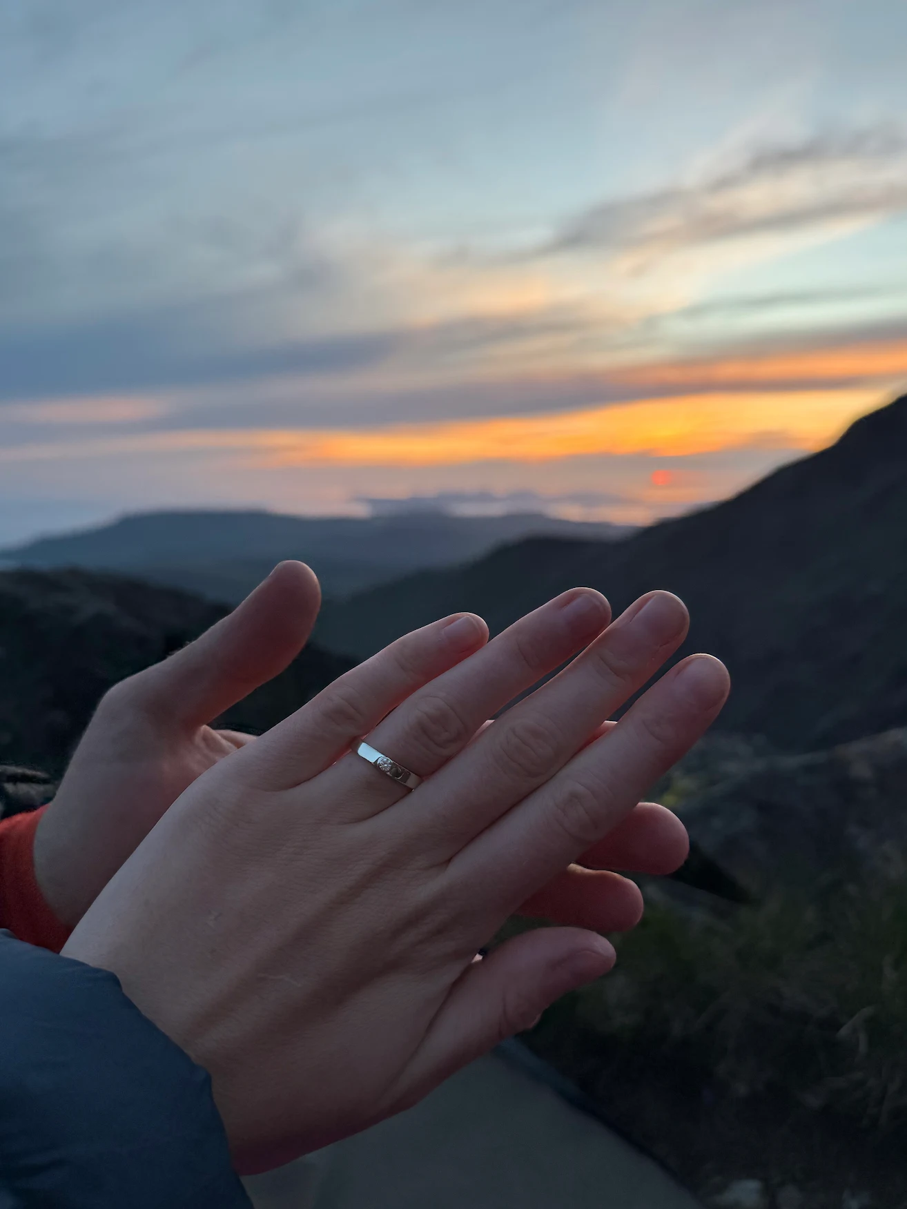 Solitaire diamond engagement ring on hand