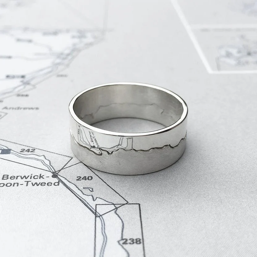 Custom silver coastline ring made from the stretch of coast between Berwick-on-Tweed and Redcar, shown on a map.