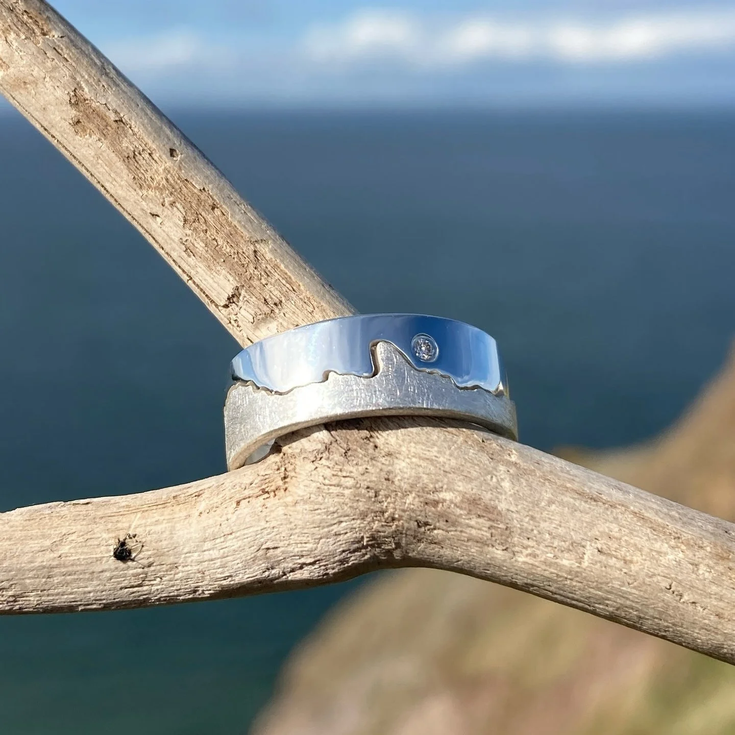 Custom silver coastline ring with diamond marker, inspired by St Andrews, Scotland.