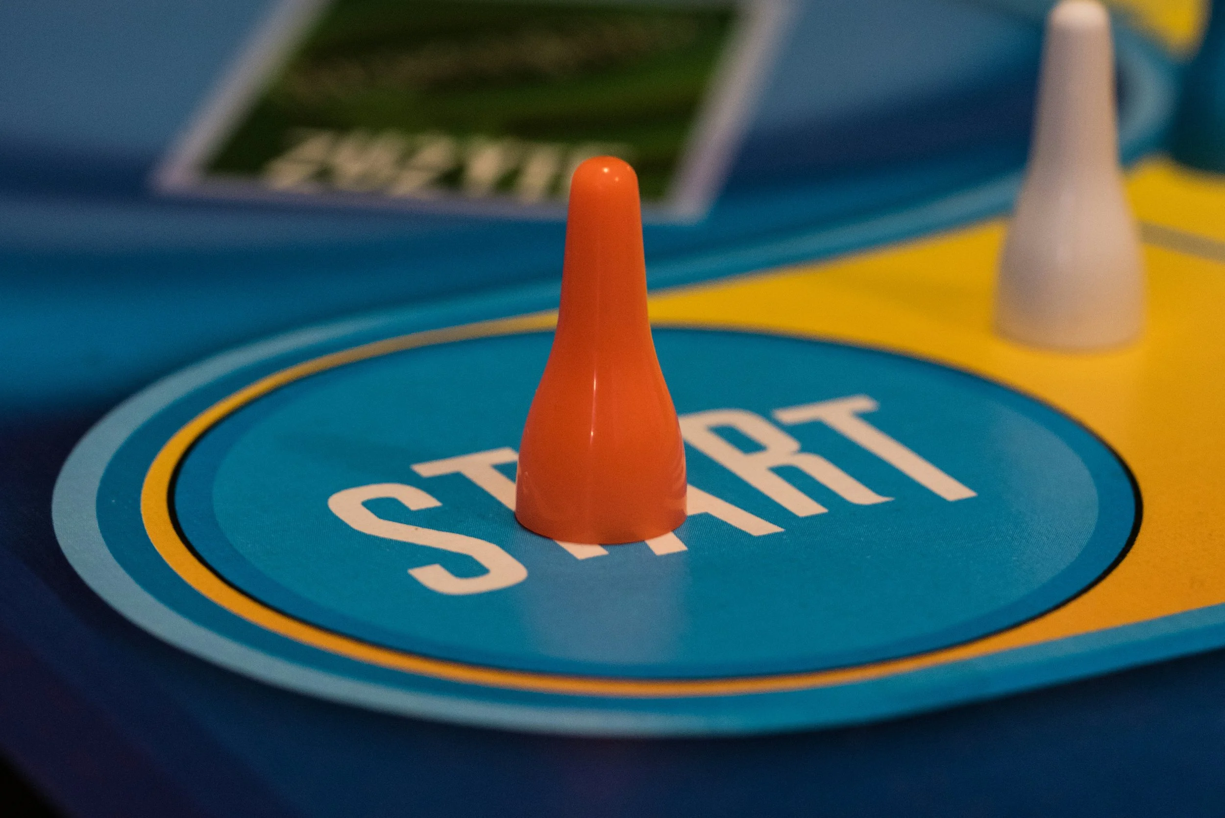 A game piece at the starting position of a game board.