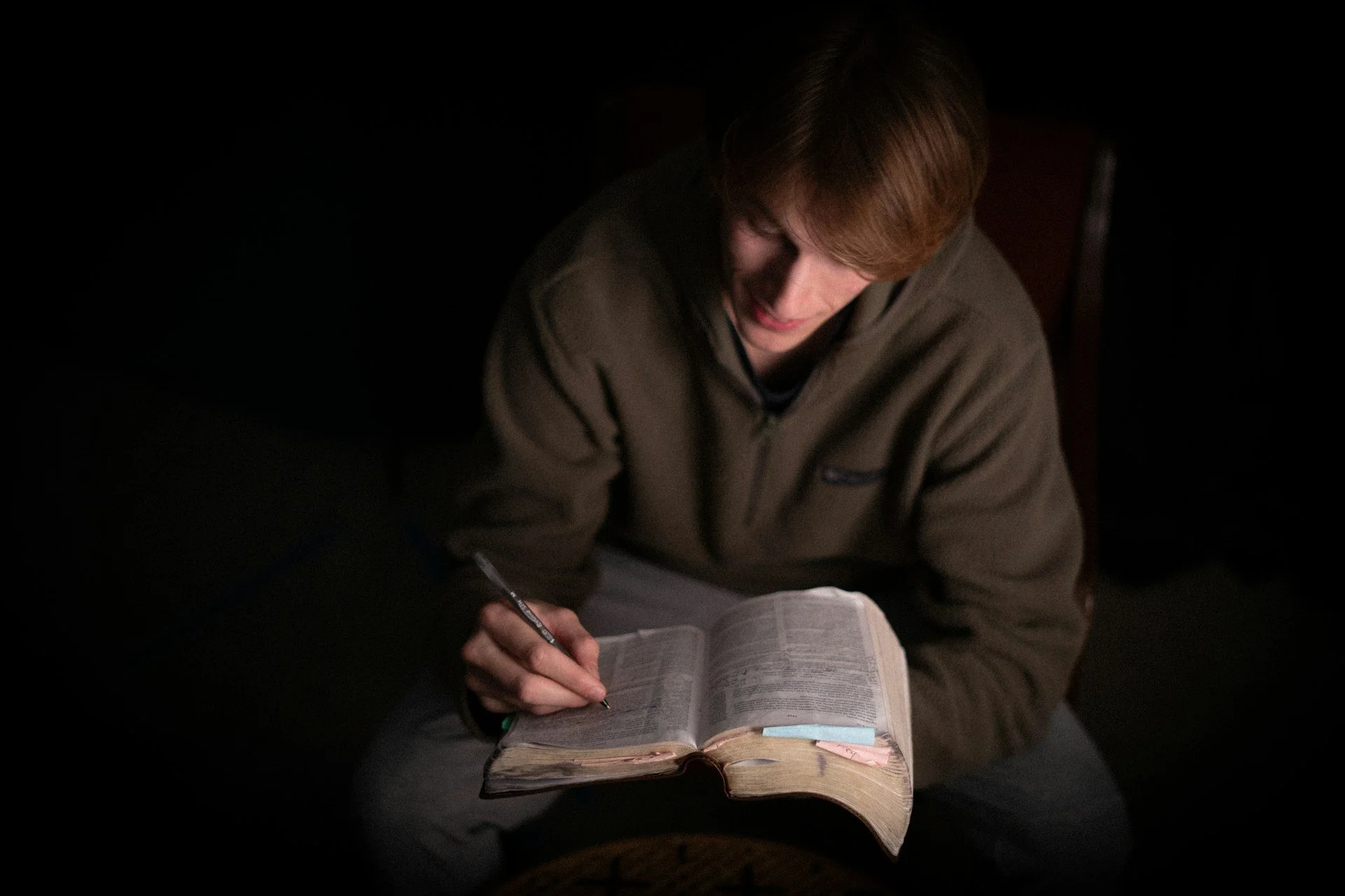 Young man studying the Bible.