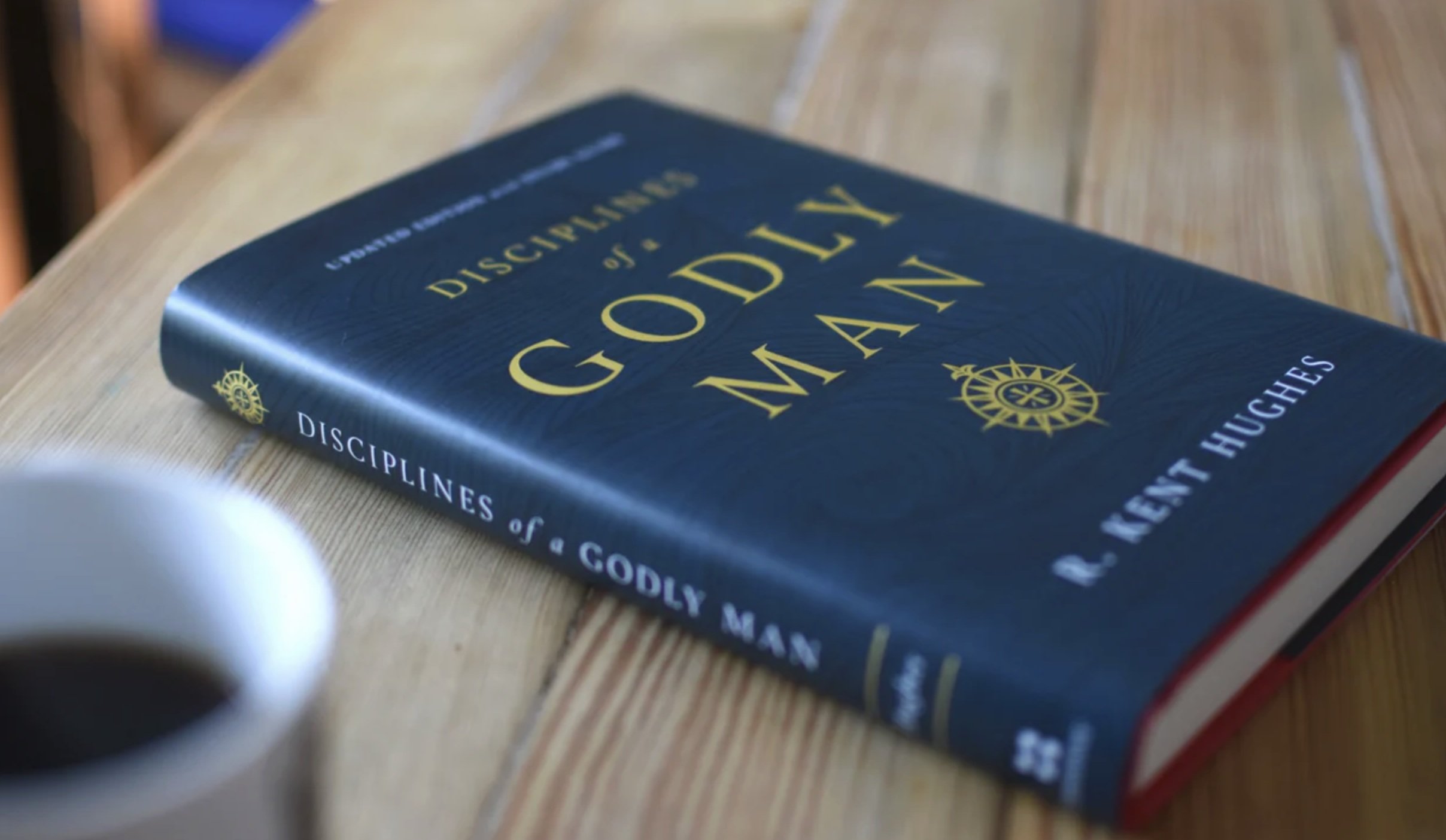 A book titled Disciplines of a Godly Man sitting on a table.