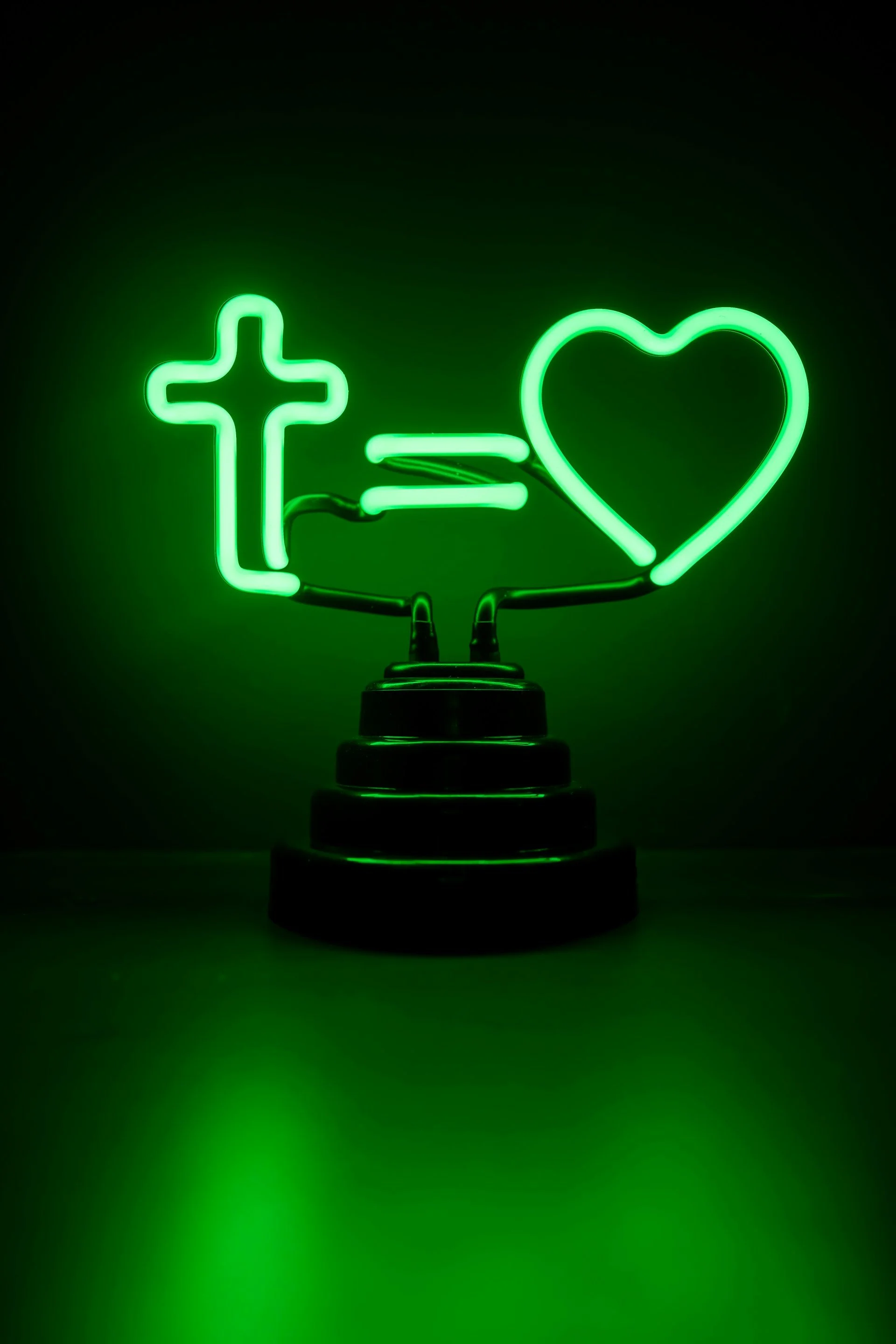 A neon light that shows the cross is equal to love.
