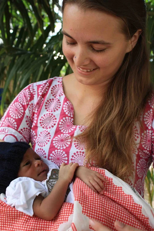 Molly and her first solo "catch", baby Mohammed, at his naming ceremony 2012.