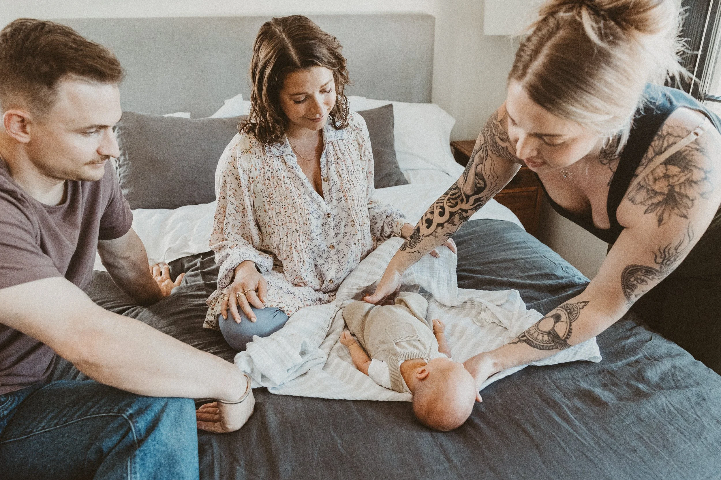 Doula educator demonstrating skills to new parents