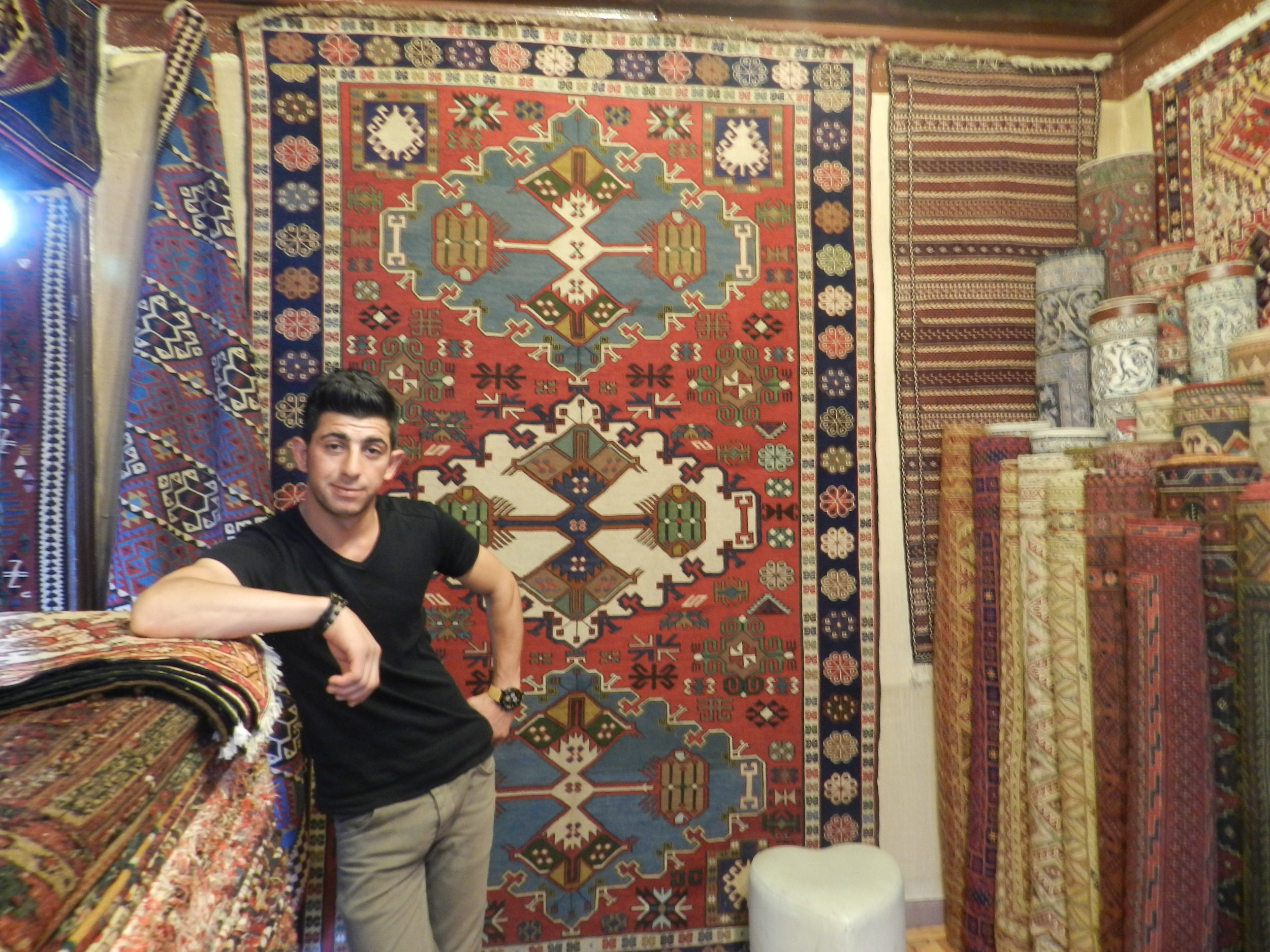 Saddam posing with his tapestries