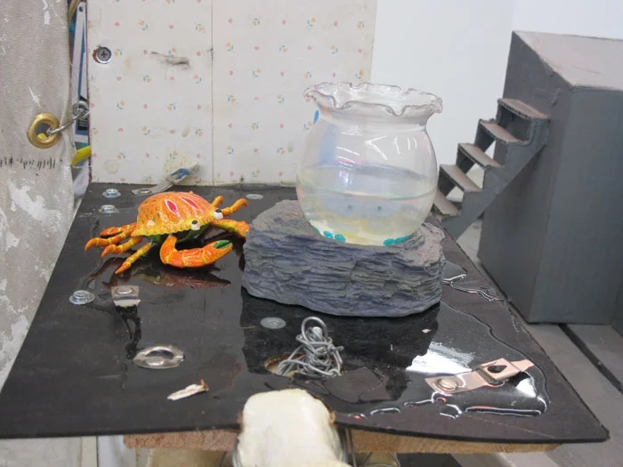 Justin Lieberman, Storygon Studio (detail), 2012, mixed media including ceramics Porygons, taxidermy crabs, 13 artist books, audio cassettes, CDs, thigh bone of giraffe, electricity, and a painting, 85 x 34 x 45 in